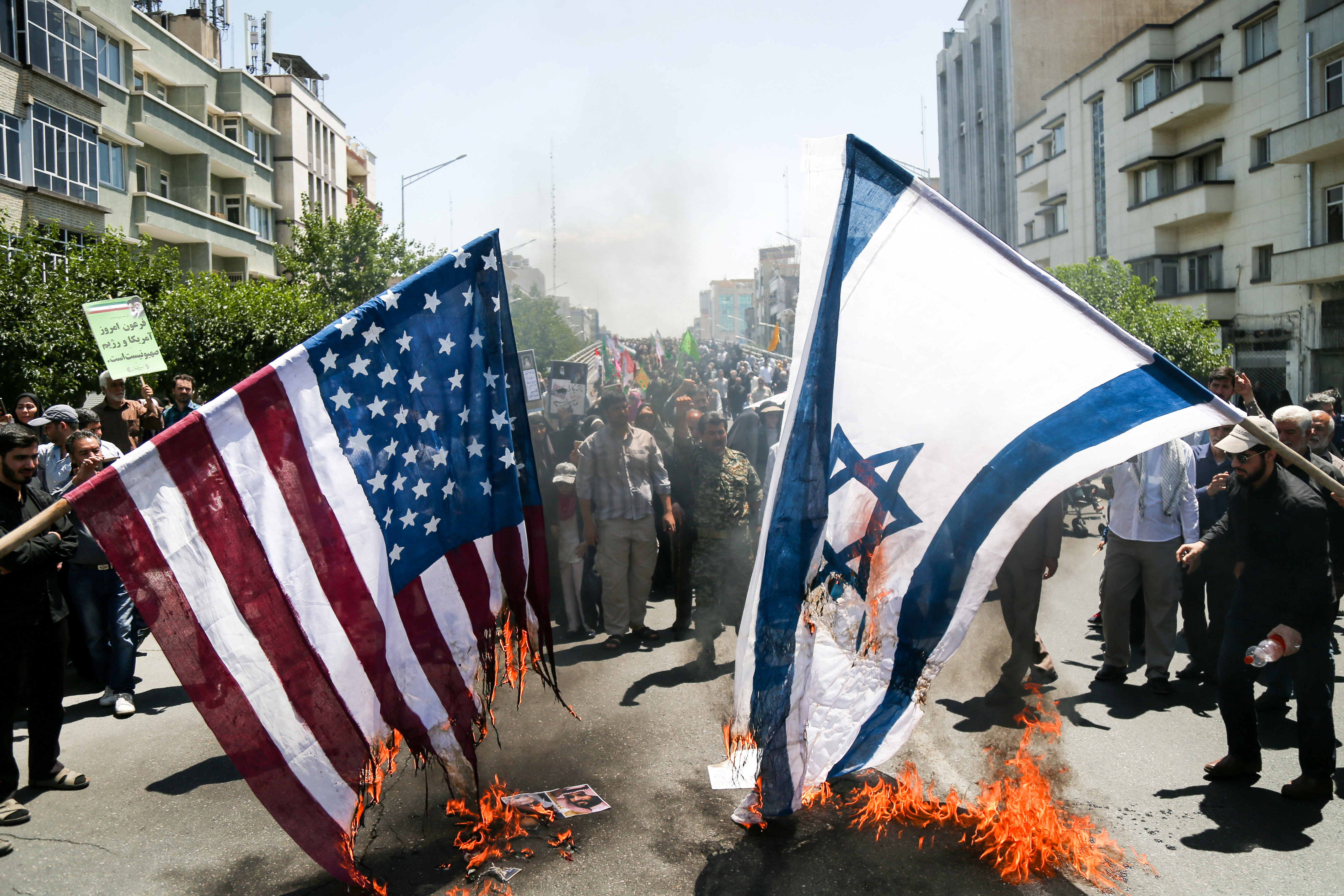 Iranians burn U.S. and Israel flags during a protest marking the annual al-Quds Day (Jerusalem Day) on the last Friday of the holy month of Ramadan in Tehran, Iran