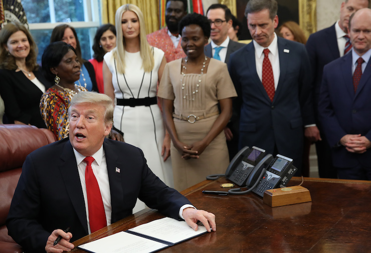 U.S. President Donald Trump signs a National Security Presidential Memorandum in the Oval Office February 7, 2019 in Washington, DC. The memorandum launches a Trump administration goal, the ‚ÄúWomen‚Äôs Global Development and Prosperity‚Äù Initiative, an initiative led by his daughter, Ivanka Trump (5th from left). (Photo by Win McNamee/Getty Images)