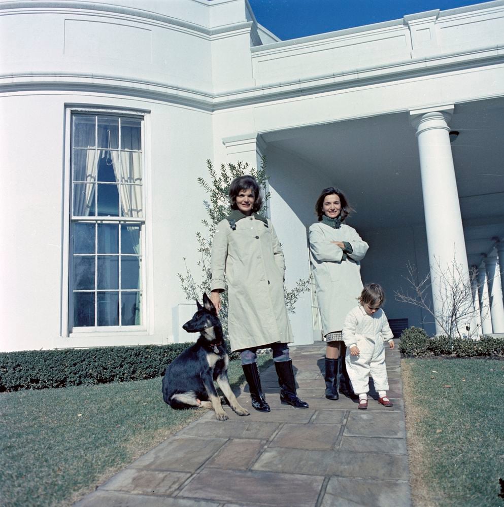 First Lady Jacqueline Kennedy (L) stands with her sister, Princess Lee Radziwill of Poland, and niece, Anna Christina Radziwill, on the walkway outside the Oval Office with the Kennedy family dog Clipper at the White House in Washington, D.C., January 15, 1963. Courtesy Cecil Stoughton/JFK Library/Handout via REUTERS 