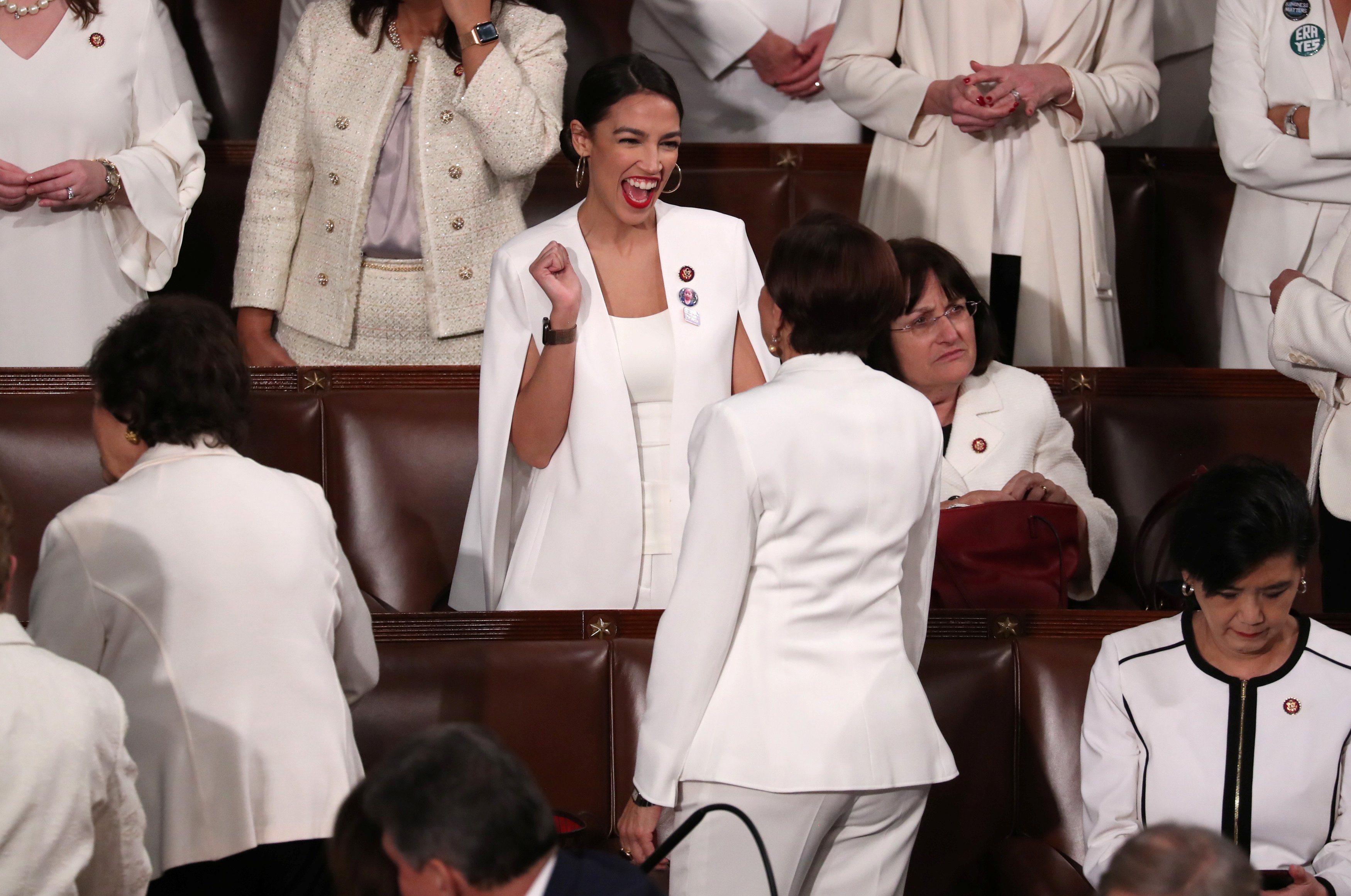 Rep. Ocasio-Cortez talks with a colleague as they await U.S. President Donald Trump's second State of the Union address to a joint session of the U.S. Congress in Washington