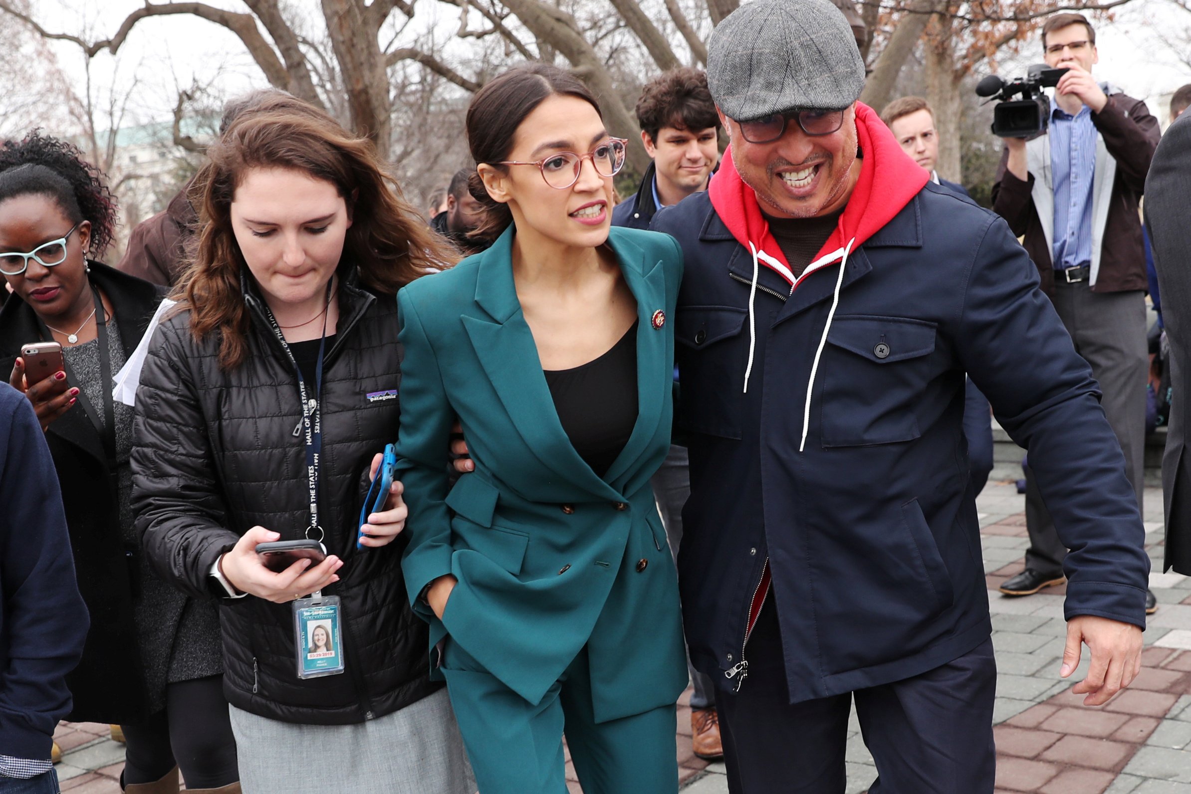 U.S. Representative Ocasio-Cortez moves through a group of reporters after a news conference for the proposed "Green New Deal" at the U.S. Capitol in Washington