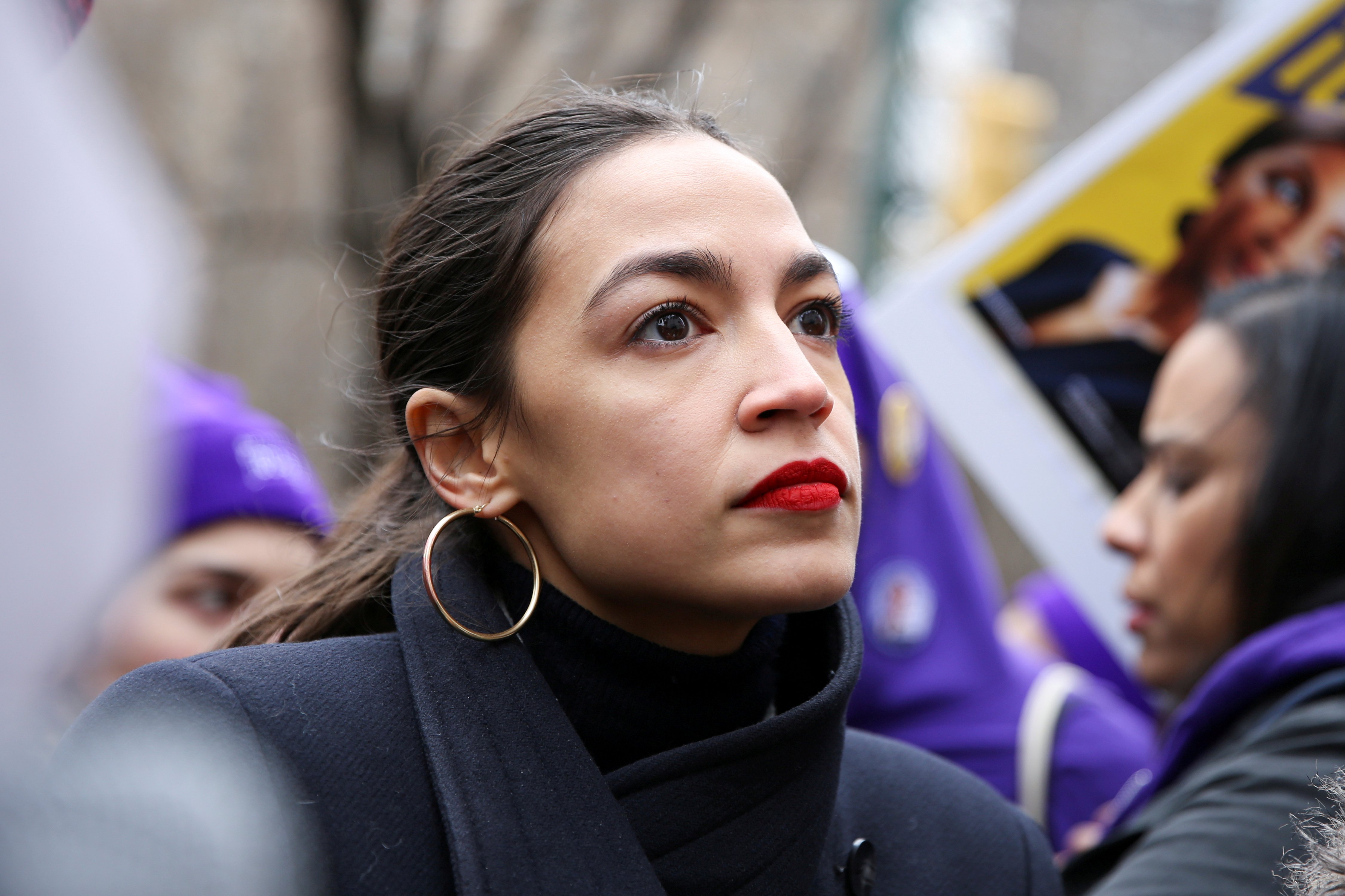 Rep. Alexandria Ocasio-Cortez looks on during a march organised by the Women's March Alliance in the Manhattan borough of New York City