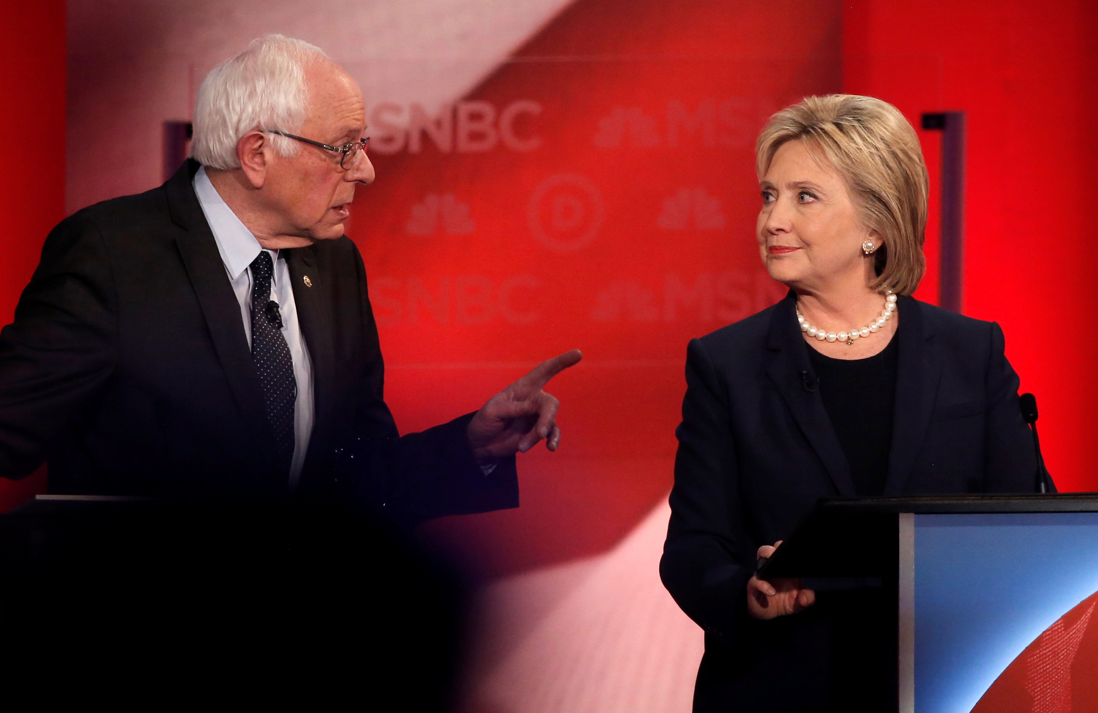 Democratic U.S. presidential candidate Senator Bernie Sanders (L) speaks directly to former Secretary of State Hillary Clinton as they discuss issues during the Democratic presidential candidates debate sponsored by MSNBC at the University of New Hampshire in Durham, New Hampshire, February 4, 2016. REUTERS/Mike Segar