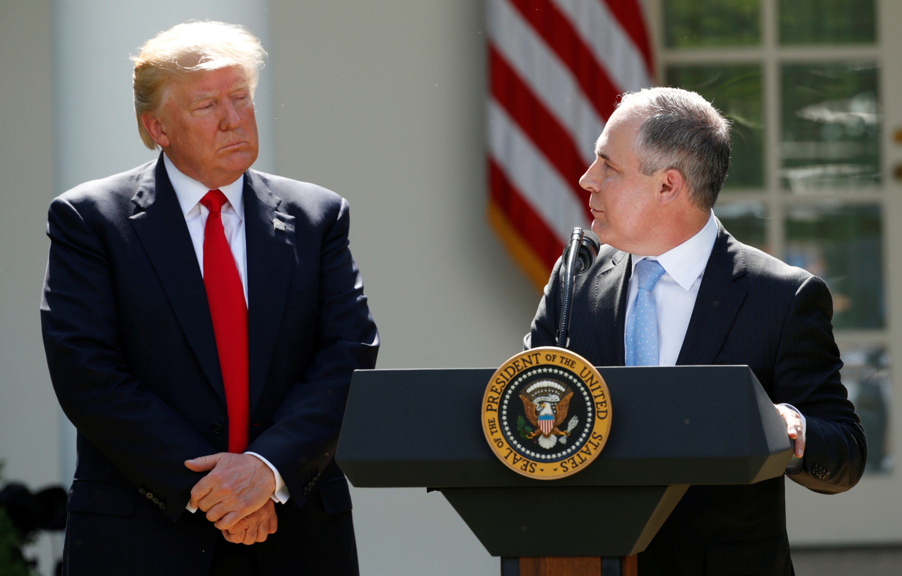 U.S. President Donald Trump (L) listens to EPA Administrator Scott Pruitt after announcing his decision that the United States will withdraw from the Paris Climate Agreement, in the Rose Garden of the White House in Washington, U.S., June 1, 2017. REUTERS/Kevin Lamarque