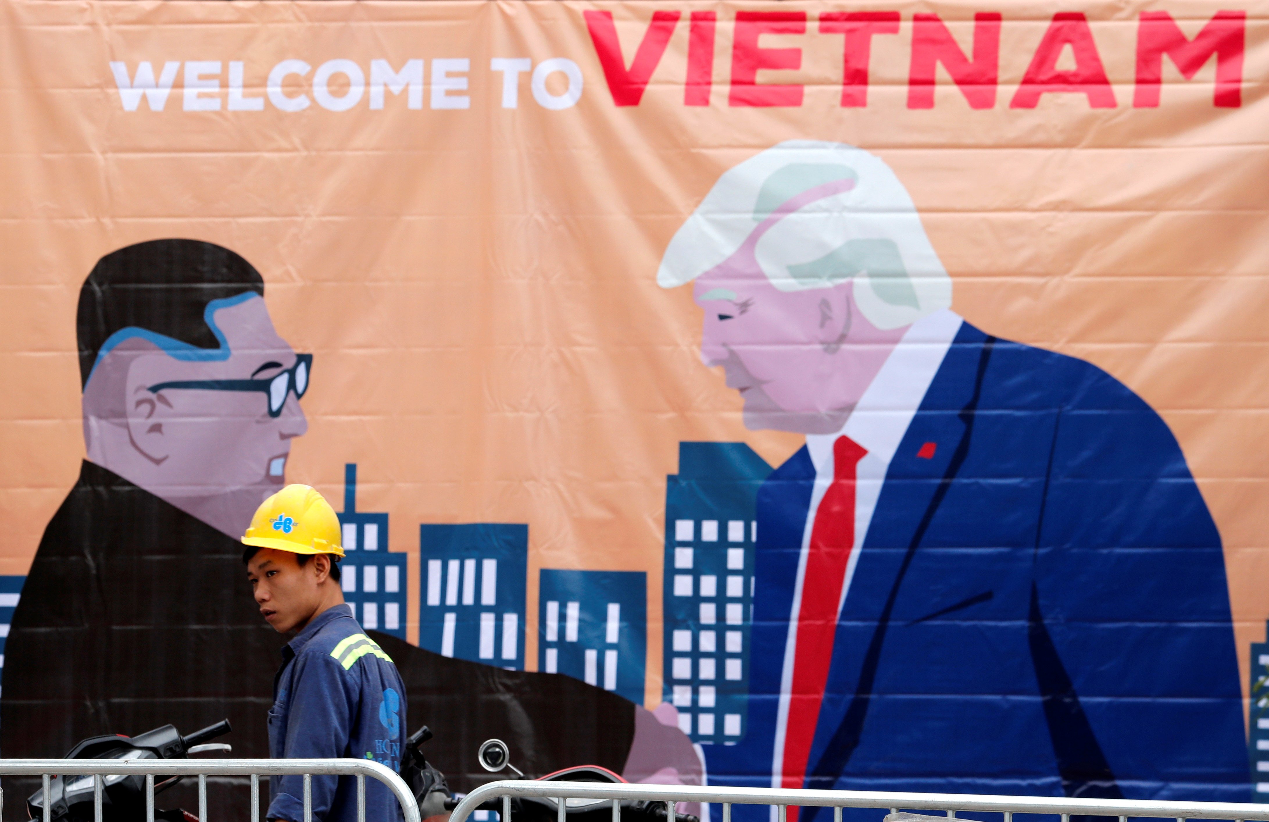A man walks past a banner depicting North Korean leader Kim Jong Un and U.S. President Donald Trump ahead of the North Korea-U.S. summit in Hanoi, Vietnam, February 25, 2019. REUTERS/Kim Kyung-Hoon 