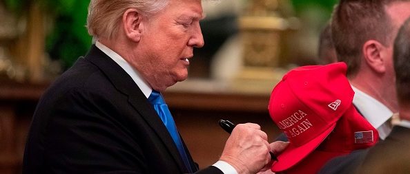 US President Donald Trump signs hats after addressing the Young Black Leadership Summit at the White House on October 26, 2018 in Washington, DC. (Photo credit ALEX EDELMAN/AFP/Getty Images)