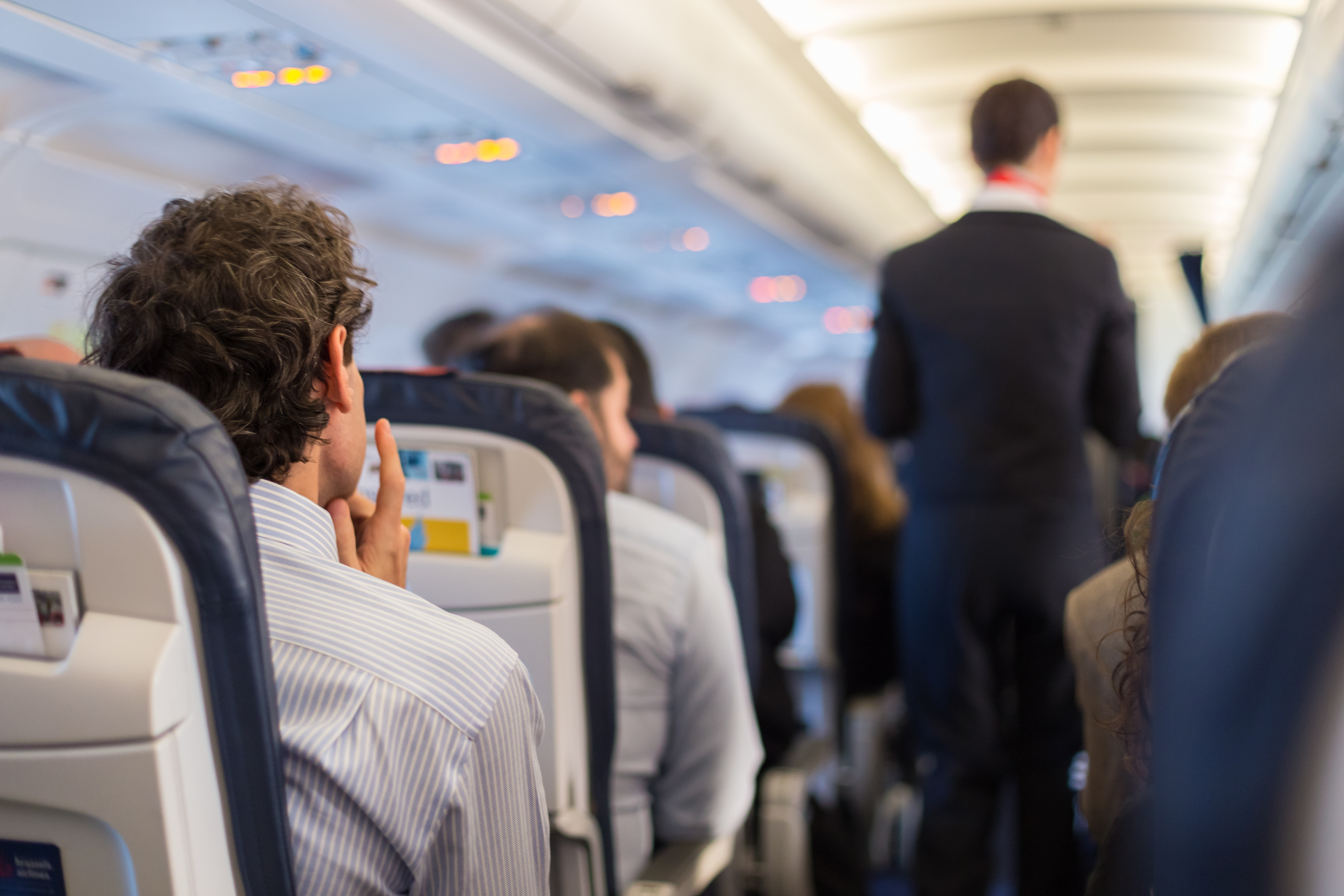 Passengers sit on a plane. Shutterstock image via user Matej Kastelic