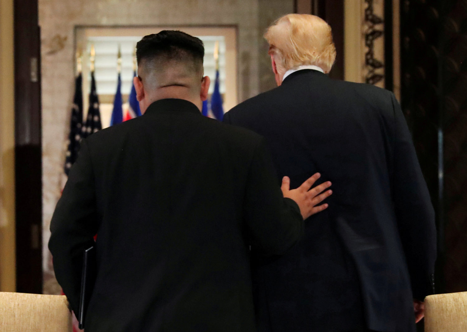 U.S. President Donald Trump and North Korea's leader Kim Jong Un leave after signing documents that acknowledge the progress of the talks and pledge to keep momentum going, after their summit at the Capella Hotel on Sentosa island in Singapore June 12, 2018. REUTERS/Jonathan Ernst