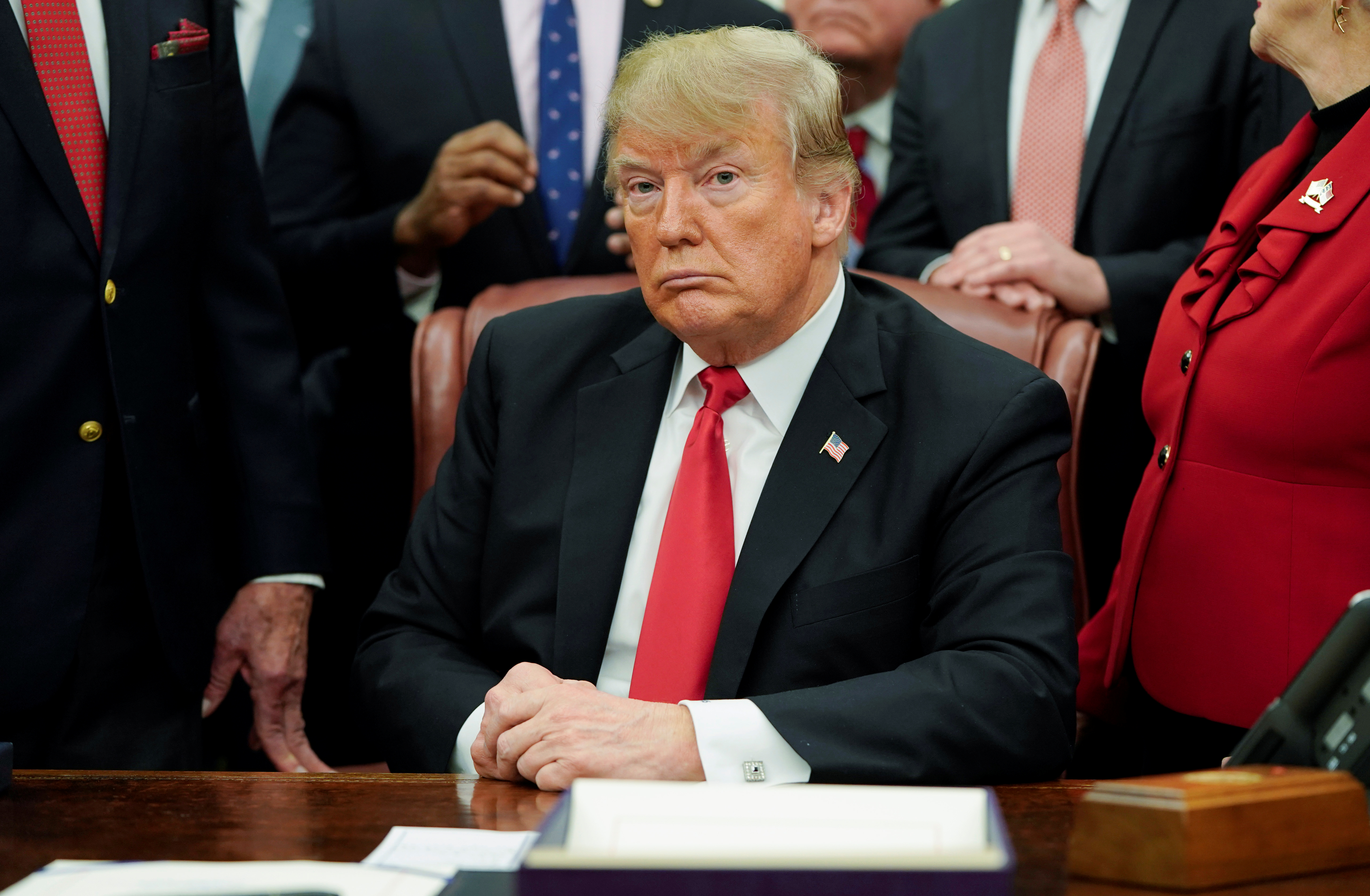 U.S. President Donald Trump listens to questions from reporters about an impending U.S. Government shutdown... (Photo by REUTERS/Joshua Roberts)
