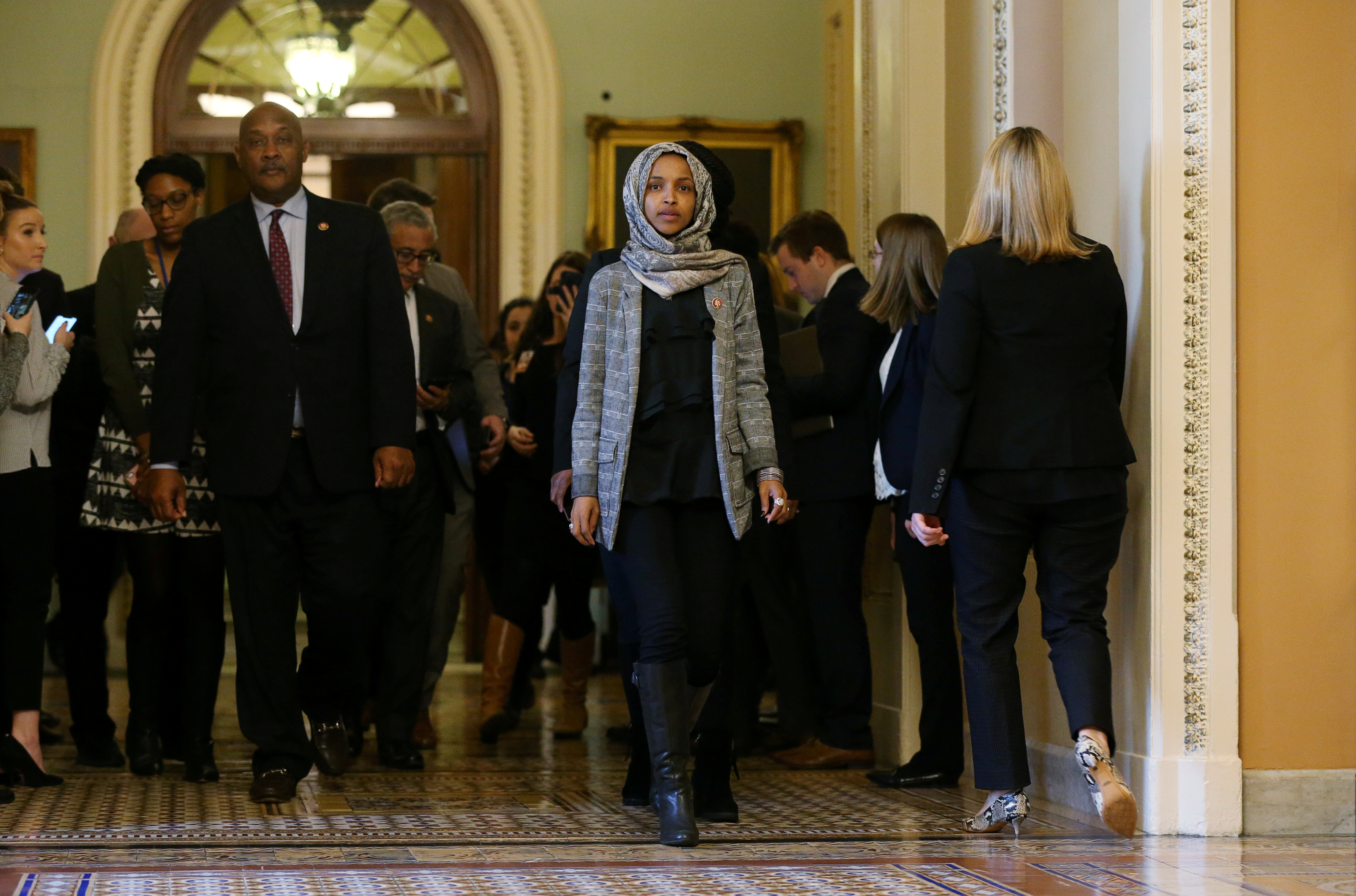 FILE PHOTO: U.S. Rep. Ilhan Omar (D-MN) leaves the U.S. Senate chamber and walks back to the House of Representatives side of the Capitol with colleagues after watching the failure of both competing Republican and Democratic proposals to end the partial government shutdown in back to back votes on Capitol Hill in Washington, U.S., January 24, 2019. REUTERS/Leah Millis/File Photo
