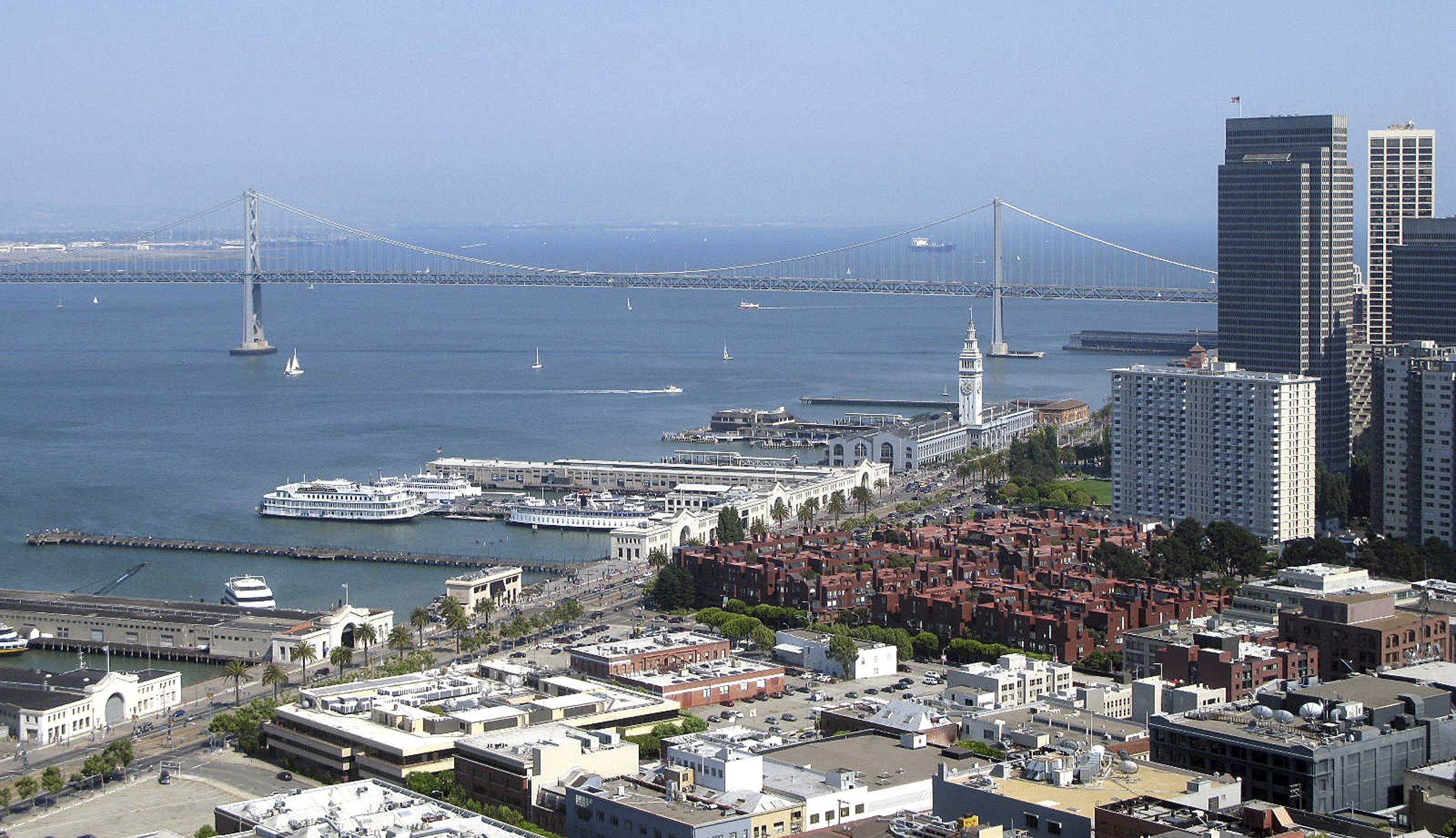 The Embarcadero district of San Francisco looking toward the Oakland Bay Bridge is seen from the Coit Tower in this photo taken July 13, 2008. A 27.1 percent slump in June from a year earlier pushed the median price paid for a home in the San Francisco Bay area, one of the priciest U.S. housing markets, to below $500,000 for the first time in four years, a report said July 17, 2008. Photo taken July 13, 2008. REUTERS/Lisa Baertlein