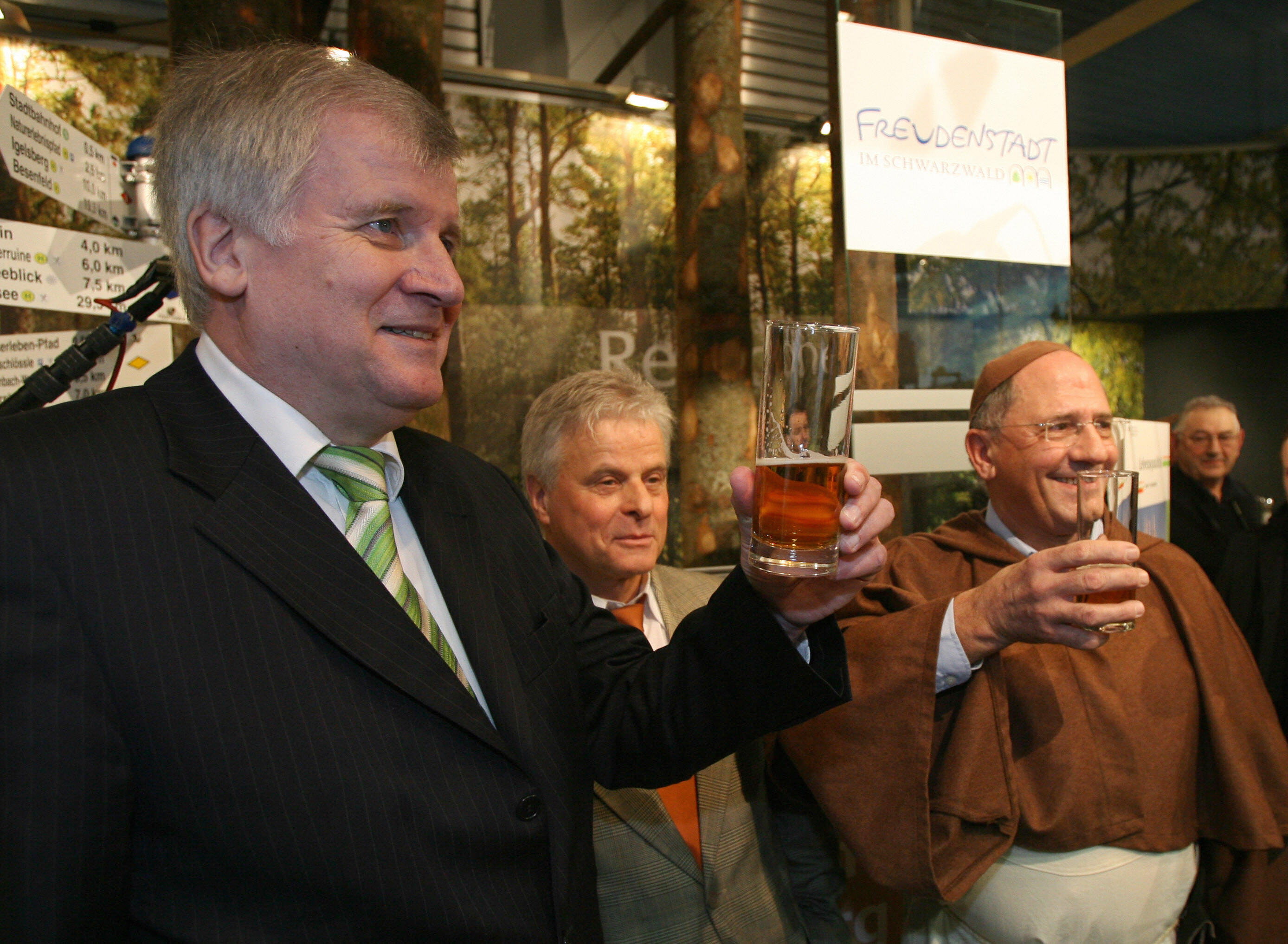 German Consumer Protection, Food and Agriculture Minister Horst Seehofer (L) holds his glass of beer up as he drinks with an employee dressed as a monk at the German Agriculture Ministry's stand of the "Gruene Woche" international food and agriculture fair in Berlin 17 January 2008. (JOHN MACDOUGALL/AFP/Getty Images)