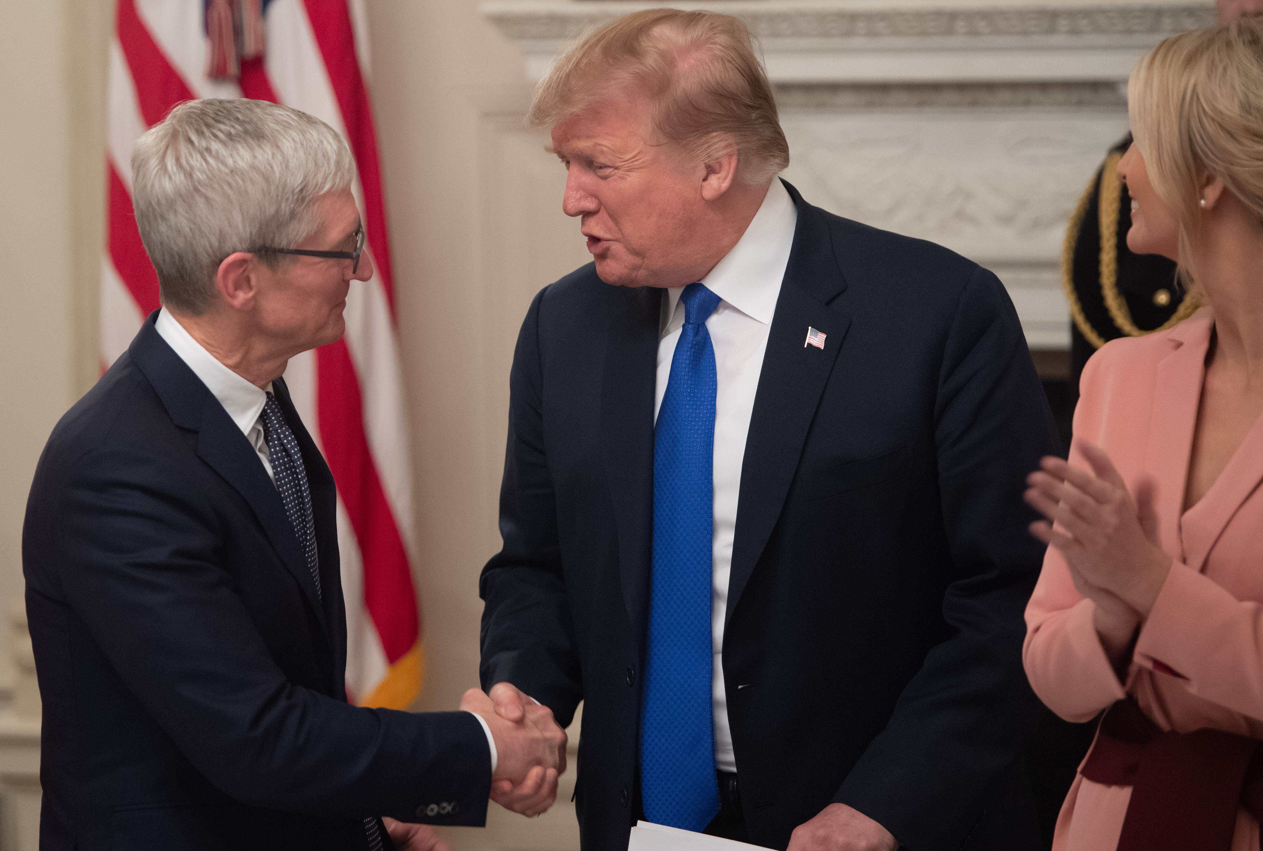 US President Donald Trump shakes hands with Apple CEO Tim Cook (L) during the first meeting of the American Workforce Policy Advisory Board in the State Dining Room of the White House in Washington, DC, March 6, 2019. (SAUL LOEB/AFP/Getty Images)