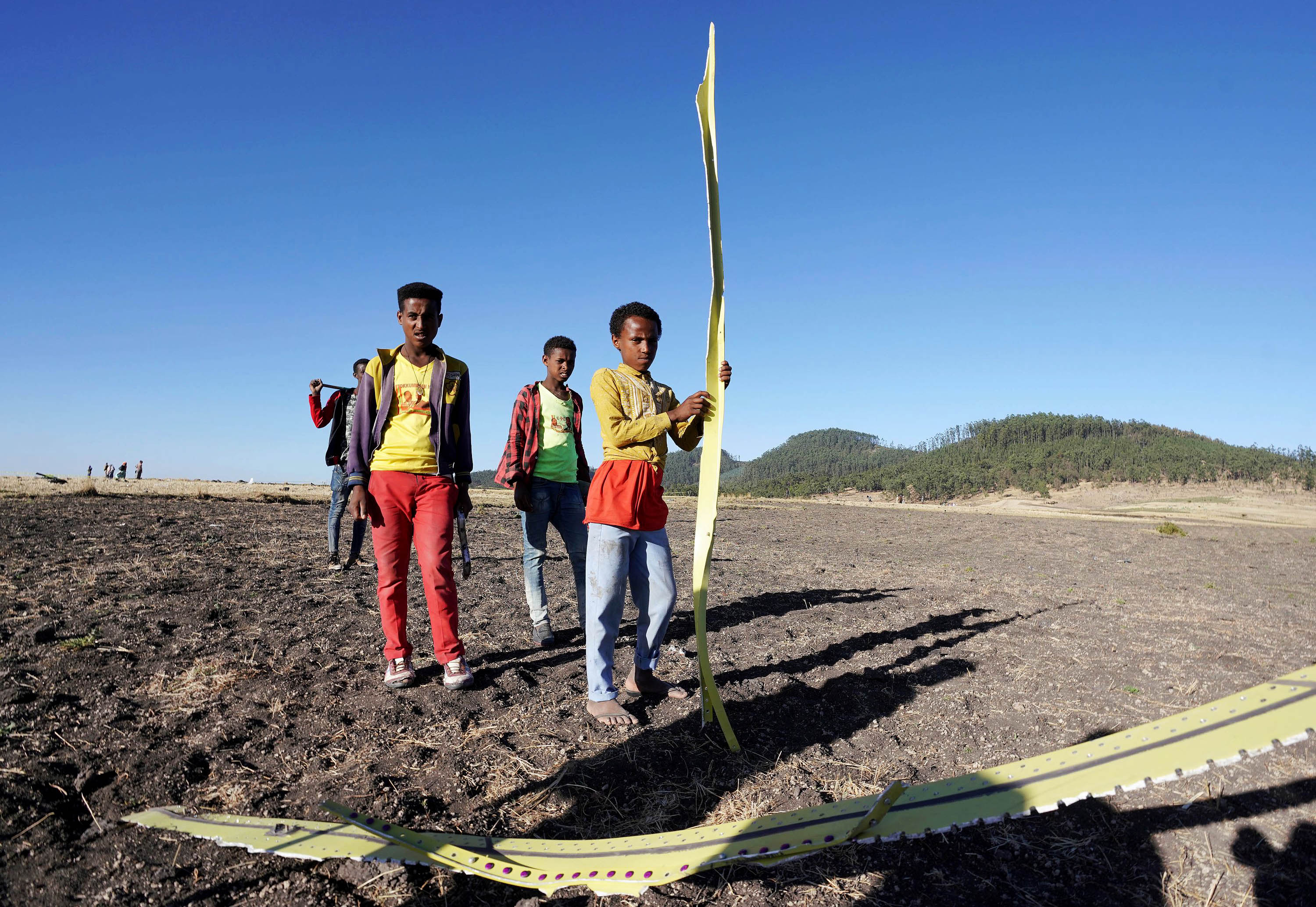 Local residents collect debris at the scene where Ethiopian Airlines Flight 302 crashed in a wheat field just outside the town of Bishoftu, 62 kilometers southeast of Addis Ababa on March 10, 2019 in Addis Ababa, Ethiopia. (Photo by Jemal Countess/Getty Images)