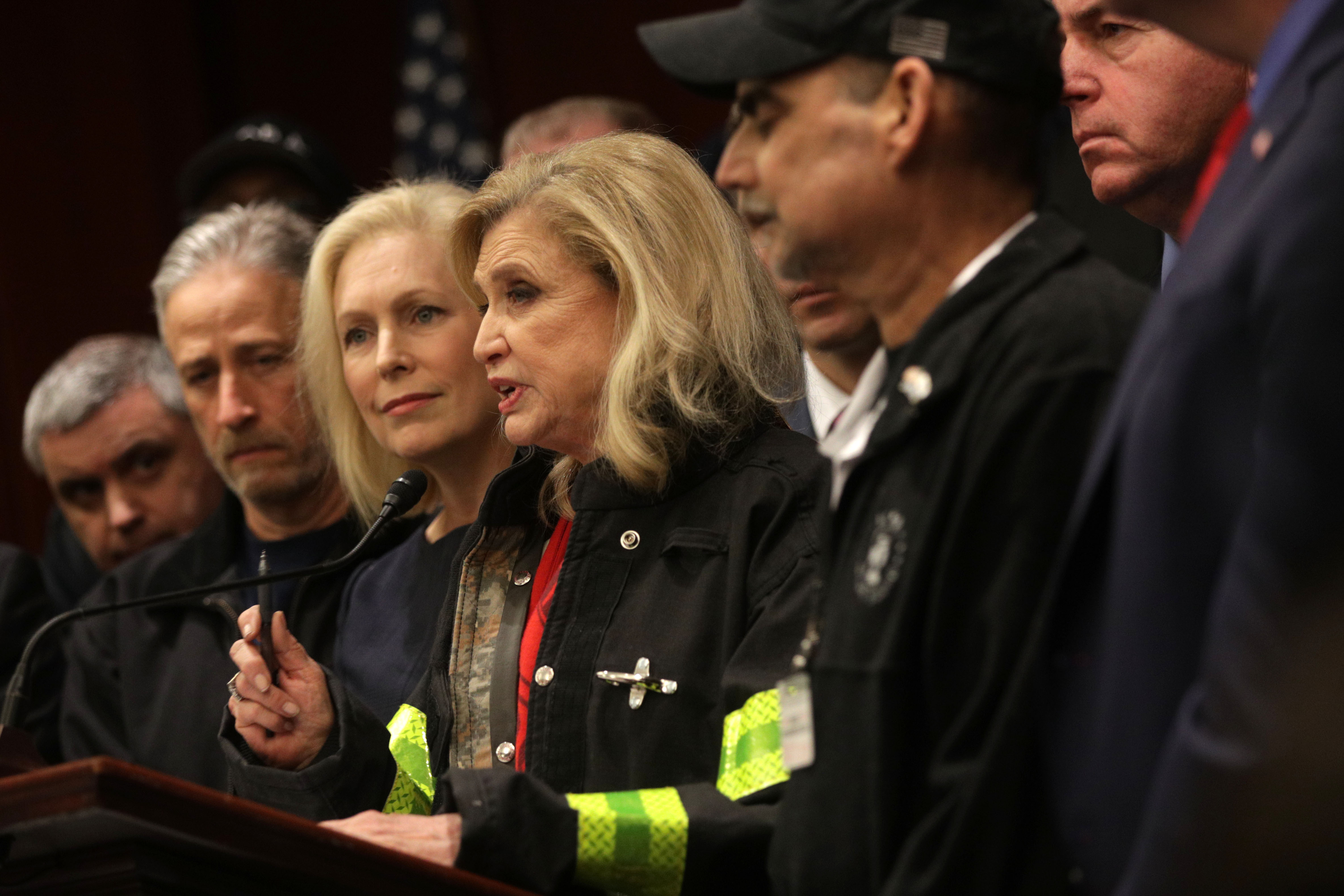 U.S. Rep. Carolyn Maloney (4th L) speaks as Sen. Kirsten Gillibrand (3rd L) and former "The Daily Show" host Jon Stewart (2nd L) listen during a news conference February 25, 2019 on Capitol Hill in Washington, DC. (Photo by Alex Wong/Getty Images)