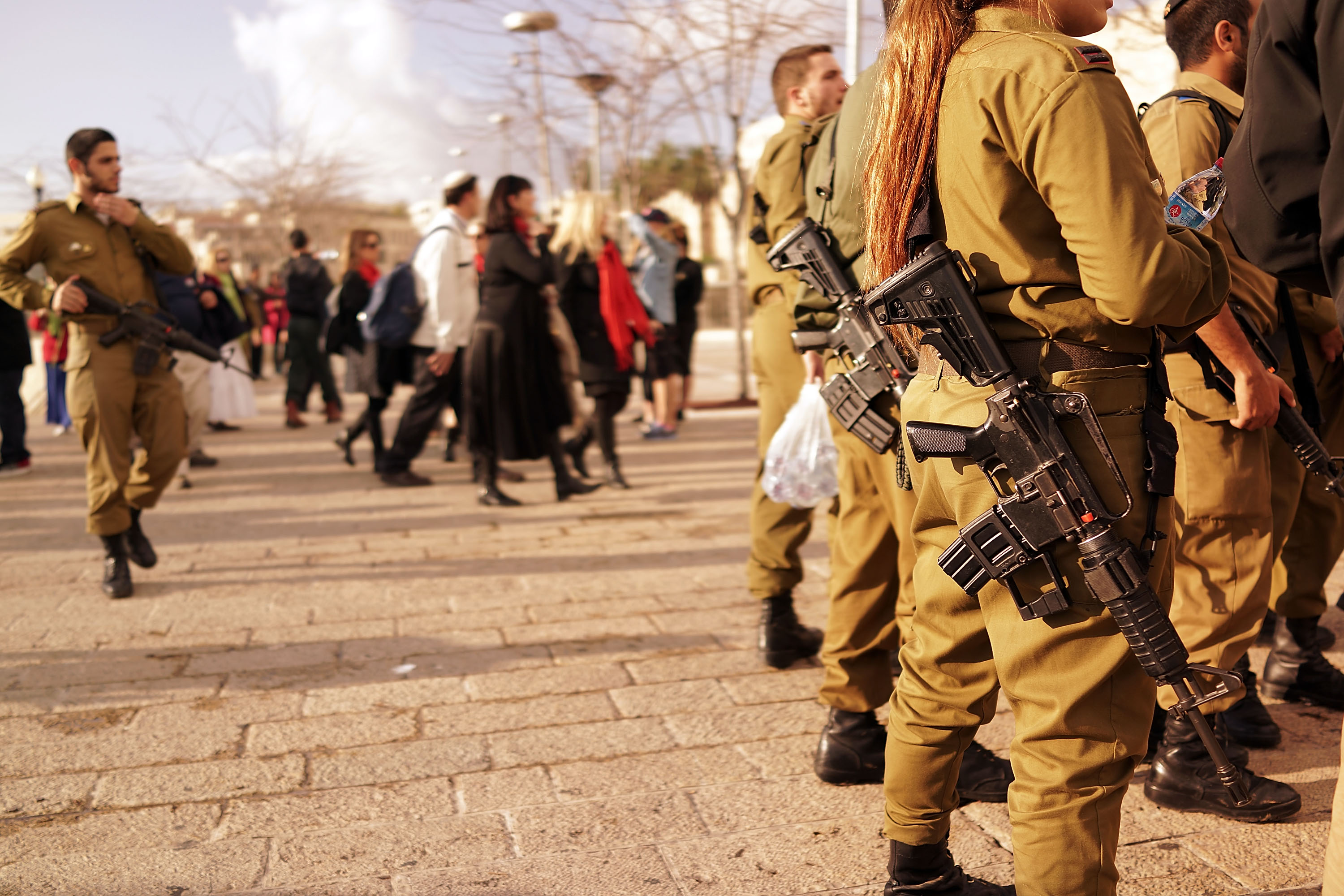 JERUSALEM, ISRAEL - NOVEMBER 28: Young members of the Israeli Defense Forces (IDF) pause in a park near the Old City on November 28, 2014 in Jerusalem, Israel. (Spencer Platt/Getty Images)
