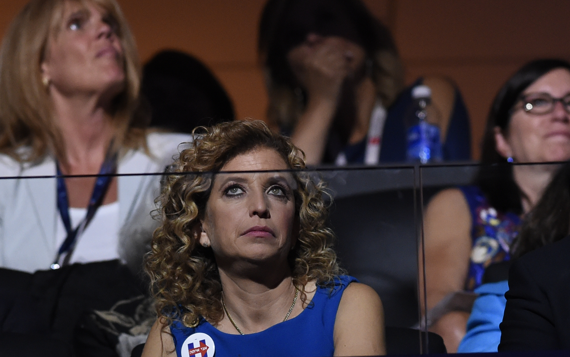 Former chairperson of the Democratic National Committee Debbie Wasserman Schultz listens to the biographical film presentation of Democratic presidential nominee Hillary Clinton during the fourth and final night of the Democratic National Convention at Wells Fargo Center on July 28, 2016 in Philadelphia, Pennsylvania. (SAUL LOEB/AFP/Getty Images)