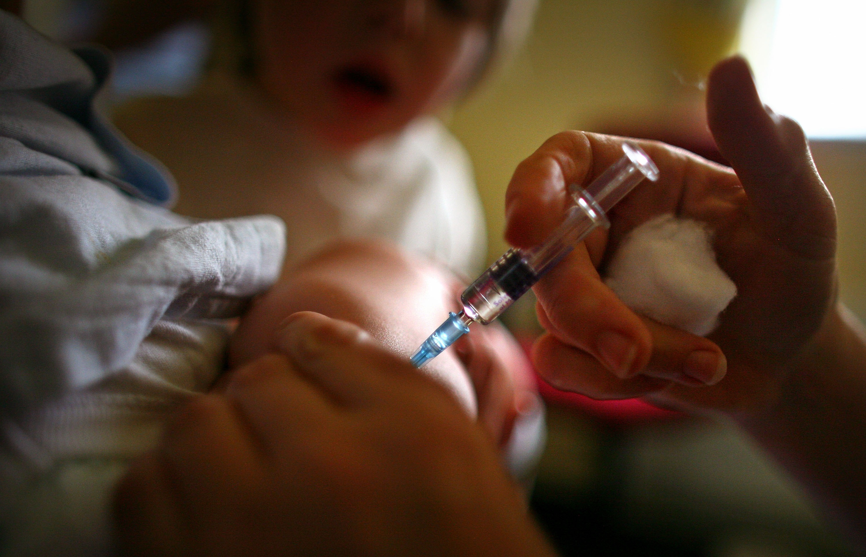 A young boy receives a immunization jab at a health centre in Glasgow September 3, 2007 ... (Photo by Jeff J Mitchell/Getty Images)