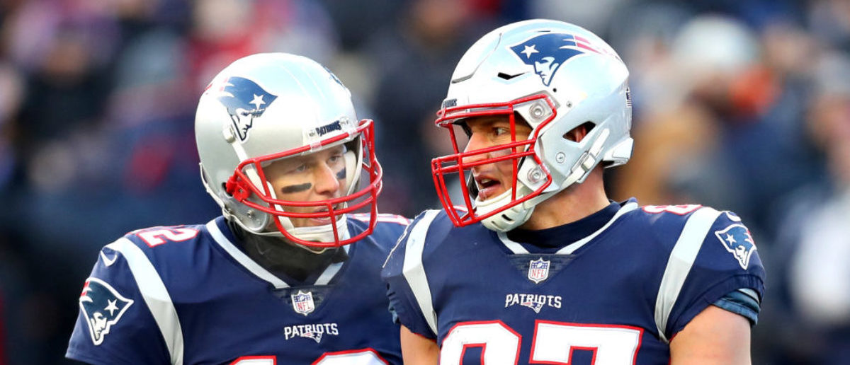 FOXBOROUGH, MASSACHUSETTS - JANUARY 13: Tom Brady #12 of the New England Patriots reacts with Rob Gronkowski #87 during the third quarter in the AFC Divisional Playoff Game against the Los Angeles Chargers at Gillette Stadium on January 13, 2019 in Foxborough, Massachusetts. (Photo by Maddie Meyer/Getty Images)
