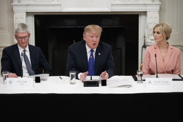 U.S. President Donald Trump delivers remarks as Apple CEO Tim Cook and Ivanka Trump look on during a meeting with the American Workforce Policy Advisory Board inside the State Dining Room on March 6, 2019 in Washington, DC. The board, co-chaired by Ivanka and Commerce Secretary Wilbur Ross, is tasked with developing a strategy to revamp the U.S. workforce for well-paid, in-demand jobs and with promoting private-sector investments in workers. (Photo by Tom Brenner/Getty Images)