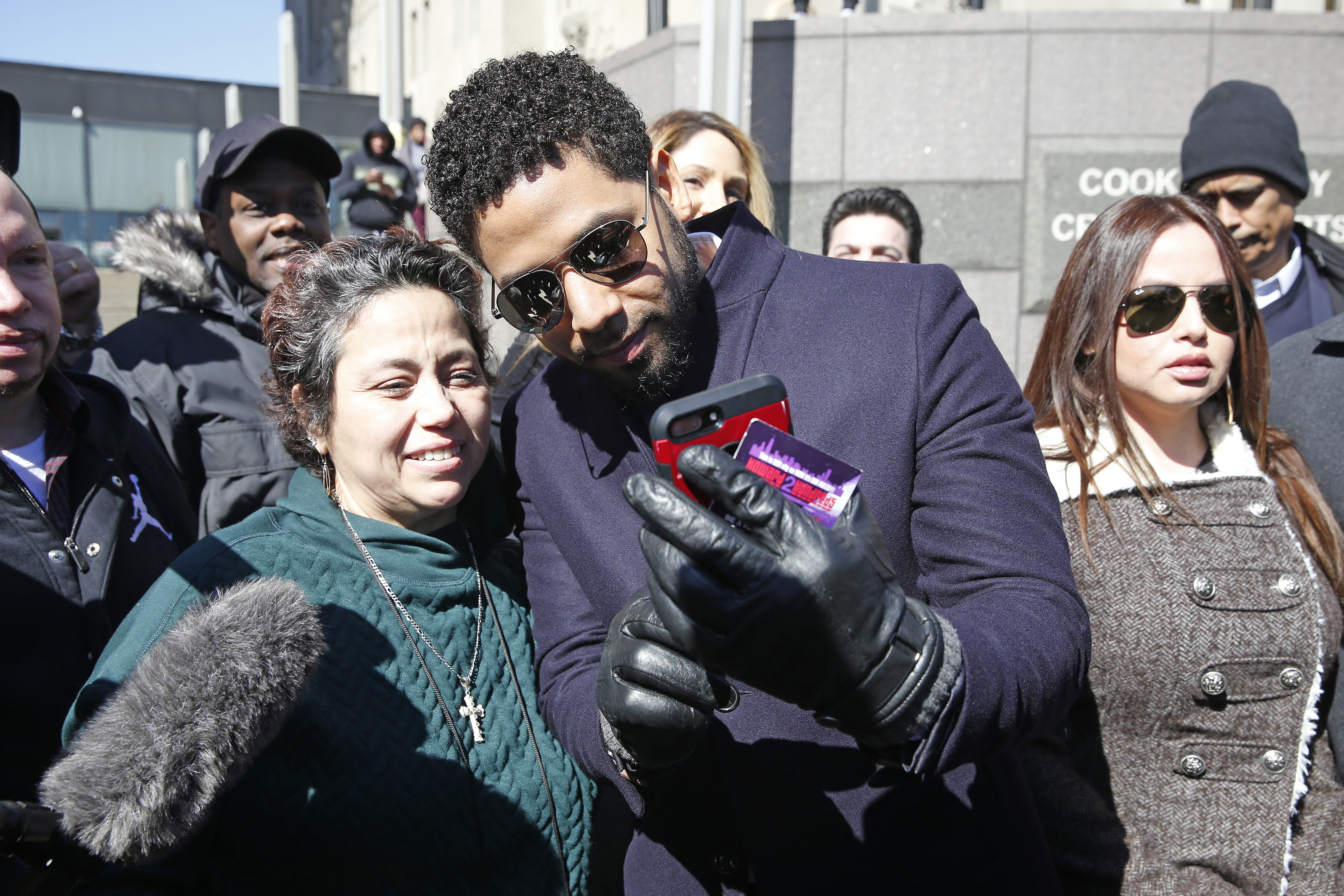 CHICAGO, ILLINOIS - MARCH 26: A fan takes a selfie with actor Jussie Smollett following his court appearance at Leighton Courthouse on March 26, 2019 in Chicago, Illinois. This morning in court it was announced that all charges were dropped against the actor. (Photo by Nuccio DiNuzzo/Getty Images)