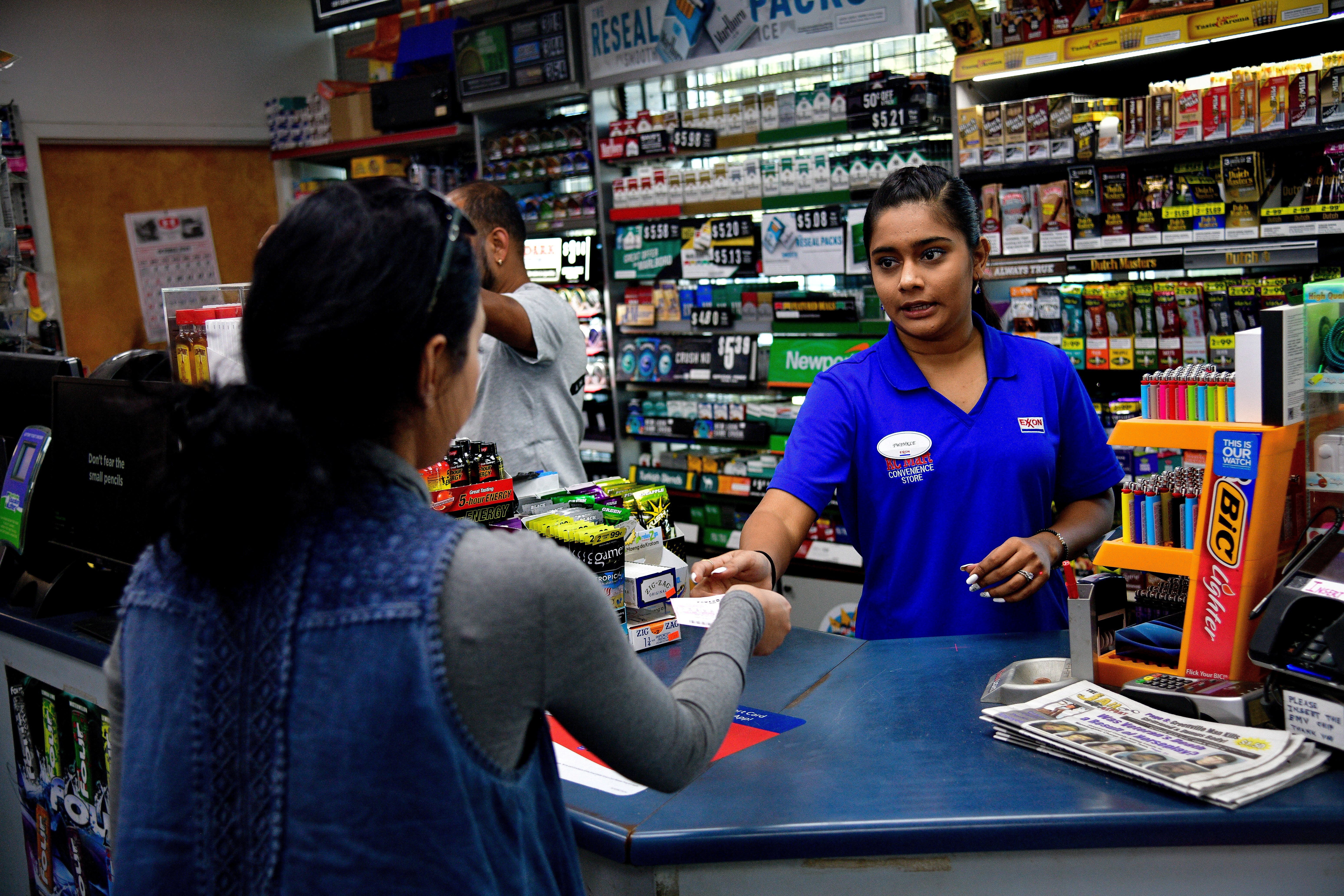 Twinkle Patel sells a Powerball ticket at the KC Mart in Simpsonville, South Carolina, U.S. October 24, 2018. REUTERS/Charles Mostoller
