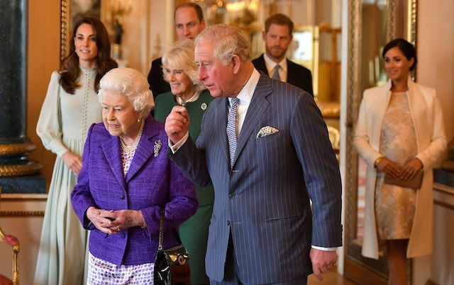 Britain's Prince Charles, Prince of Wales (C) walks with his mother Britain's Queen Elizabeth II (2L), and his wife Britain's Camilla, Duchess of Cornwall (3L), and his sons and their wives, Britain's Prince William, Duke of Cambridge (4L) and Britain's Catherine, Duchess of Cambridge (L), and Britain's Prince Harry, Duke of Sussex, (2R) and Meghan, Duchess of Sussex (R) during a reception to mark the 50th Anniversary of the investiture of The Prince of Wales at Buckingham Palace in London on March 5, 2019. - The Queen hosted a reception to mark the Fiftieth Anniversary of the investiture of Britain's Prince Charles, her son, as the Prince of Wales. Prince Charles was created The Prince of Wales aged 9 on July 26th 1958 and was formally invested with the title by Her Majesty The Queen on July 1st 1969 at Caernarfon Castle. (Photo credit: DOMINIC LIPINSKI/AFP/Getty Images)