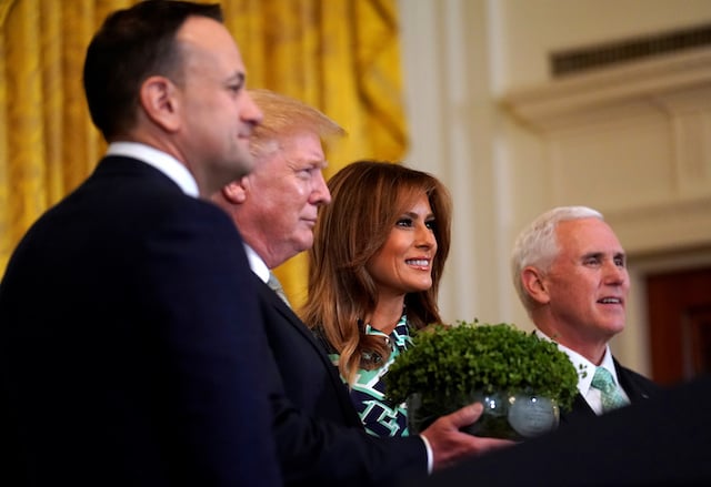 U.S. President Donald Trump, first lady Melania Trump and Vice President Mike Pence take part in the Shamrock Bowl presentation from Irish Taoiseach Leo Varadkar (L) at the White House in Washington, U.S., March 14, 2019. REUTERS/Kevin Lamarque