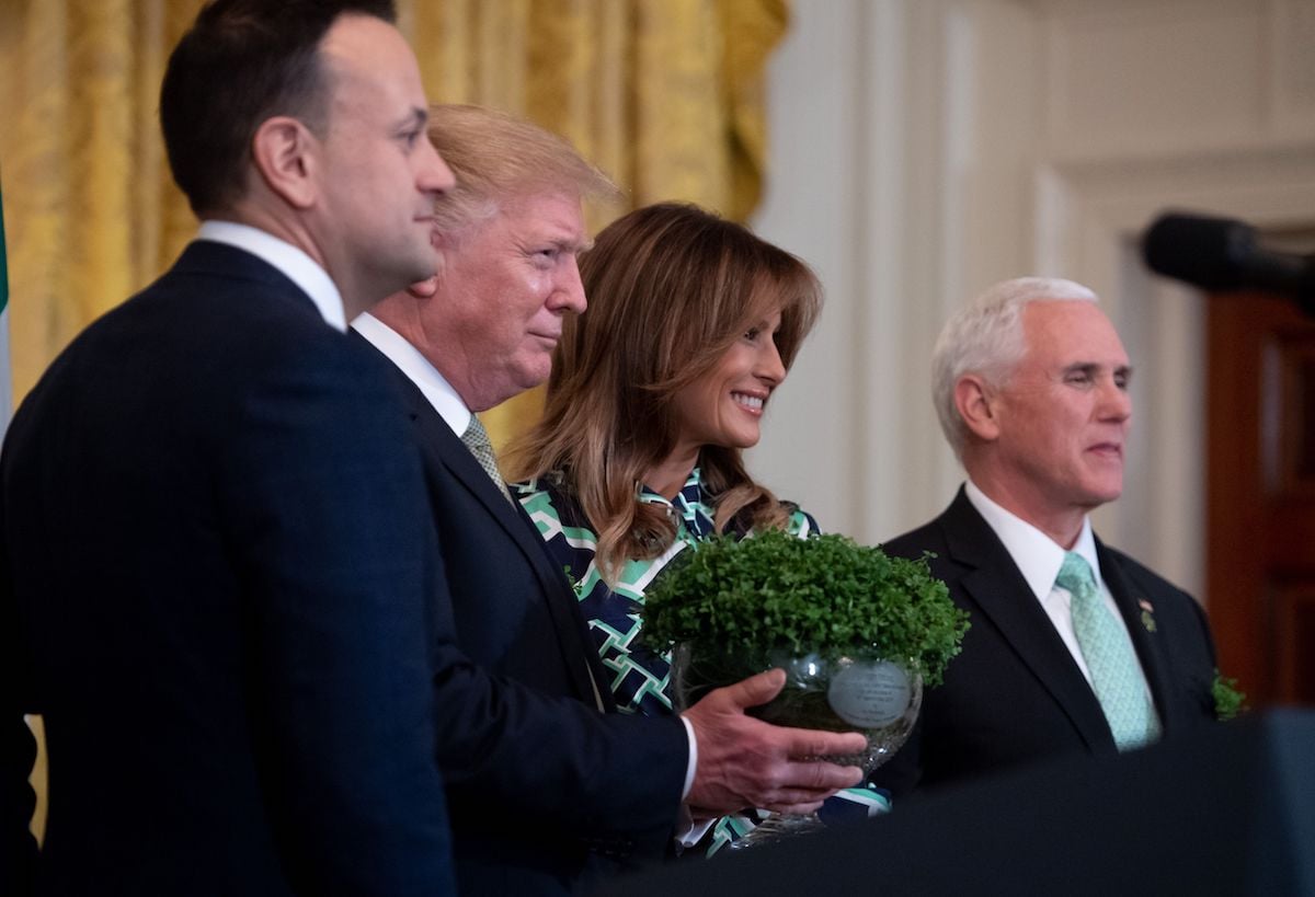 Irish Prime Minister Leo Varadkar (L) presents a bowl of shamrocks to US President Donald Trump alongside US First Lady Melania Trump (2nd R) and US Vice President Mike Pence (R) during a Shamrock Bowl Presentation in honor of St. Patrick's Day in the East Room of the White House in Washington, DC, March 14, 2019. (Photo credit: SAUL LOEB/AFP/Getty Images)