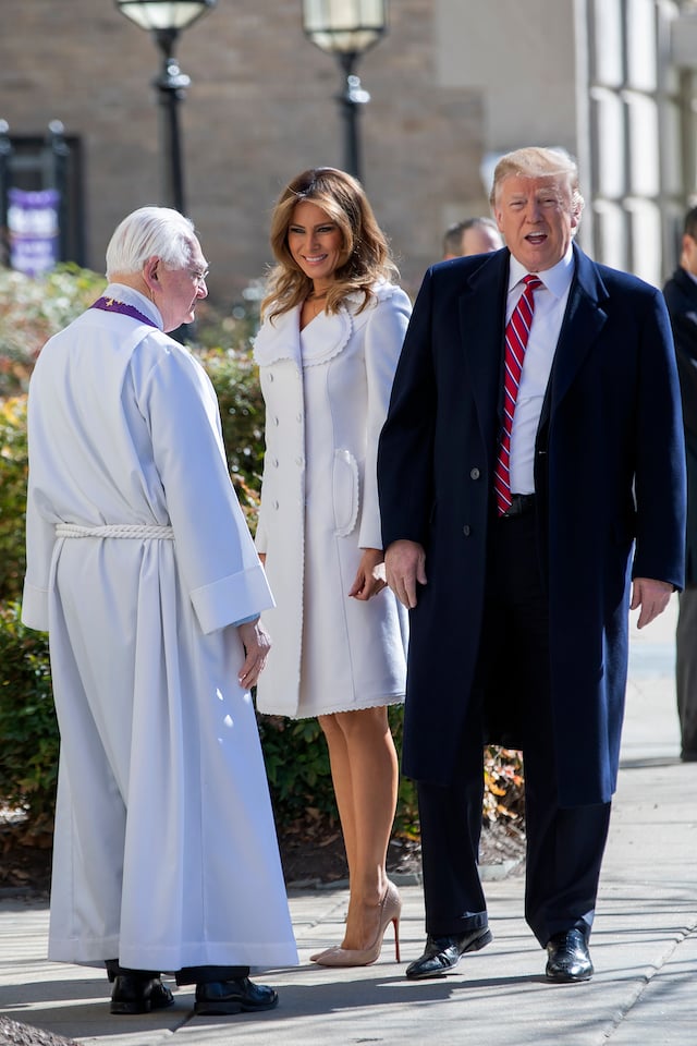 U.S. President Donald J. Trump (R) and first lady Melania Trump (C) are greeted by Reverend W. Bruce McPherson (L) as they arrive to attend services at St. John's Episcopal Church March 17, 2019 in Washington, DC, USA. The Trumps are attending church on St. Patrick's Day. (Photo by Eric Lesser - Pool/Getty Images)