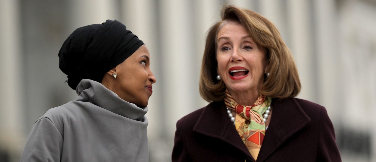 WASHINGTON, DC - MARCH 08: Rep. Ilhan Omar (D-MN) (L) talks with Speaker of the House Nancy Pelosi (D-CA) during a rally with fellow Democrats before voting on H.R. 1, or the People Act, on the East Steps of the U.S. Capitol March 08, 2019 in Washington, DC. (Photo by Chip Somodevilla/Getty Images)