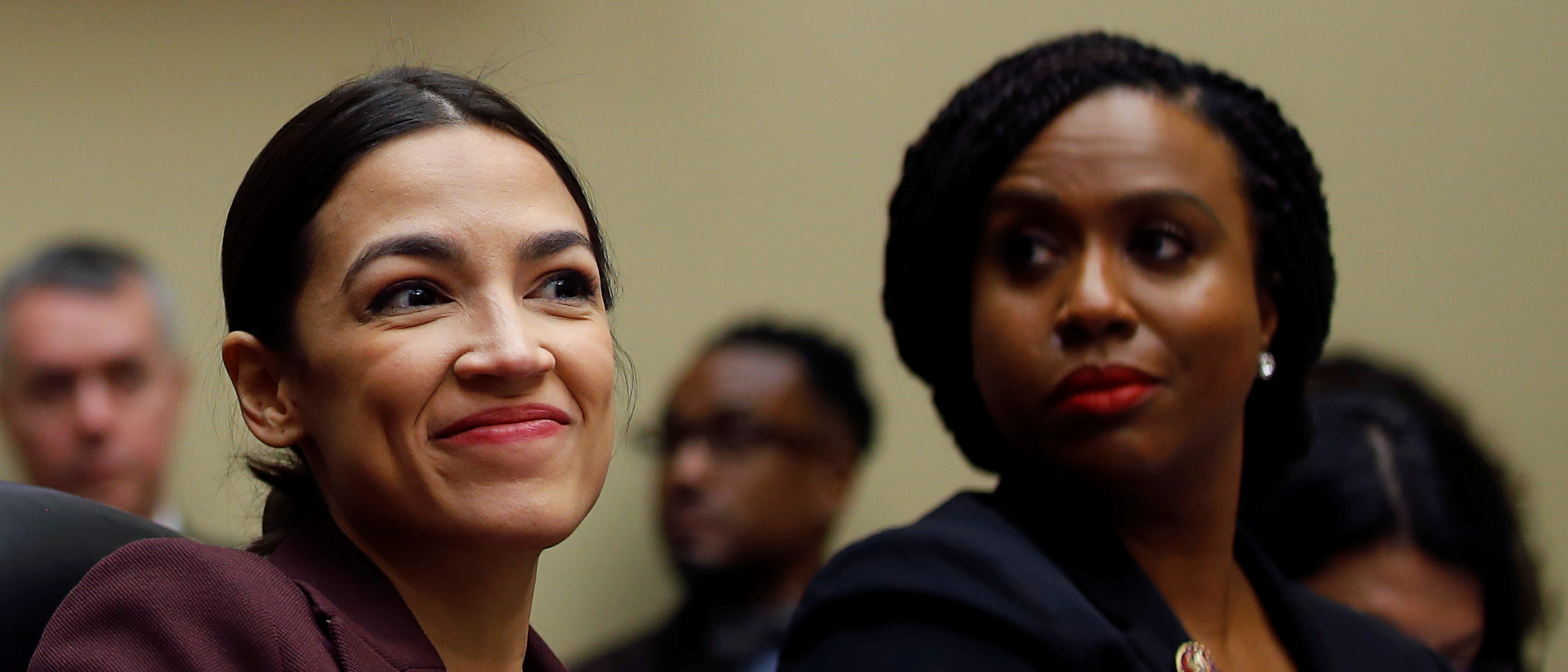 U.S. Rep. Alexandria Ocasio-Cortez (D-NY) and Rep. Ayanna Pressley (D-MA) listen to the testimony of former Trump personal attorney Michael Cohen at a House Committee on Oversight and Reform hearing on Capitol Hill in Washington, U.S., February 27, 2019. REUTERS/Carlos Barria
