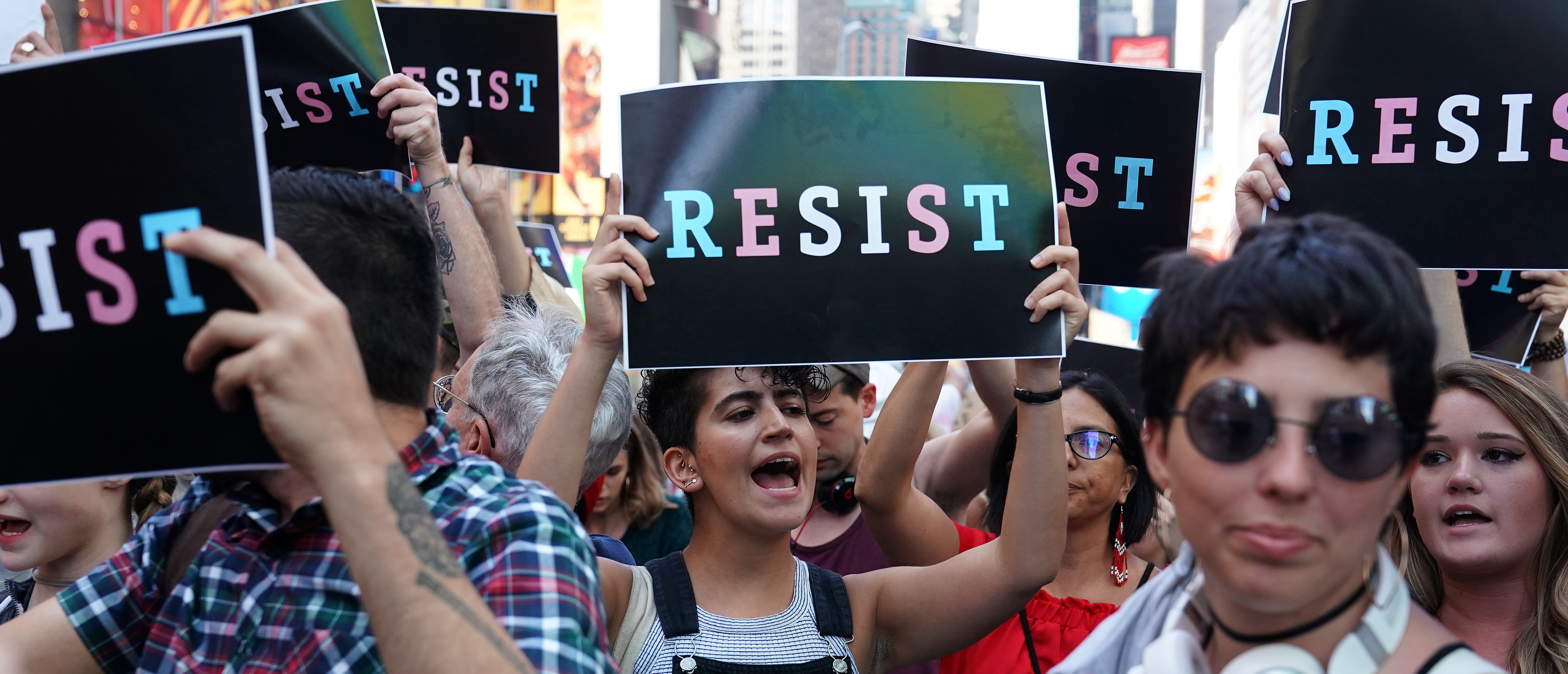 People attend a protest against U.S. President Donald Trump's announcement that he plans to reinstate a ban on transgender individuals from serving in any capacity in the U.S. military, in Times Square, in New York City, New York, U.S., July 26, 2017. REUTERS/Carlo Allegri