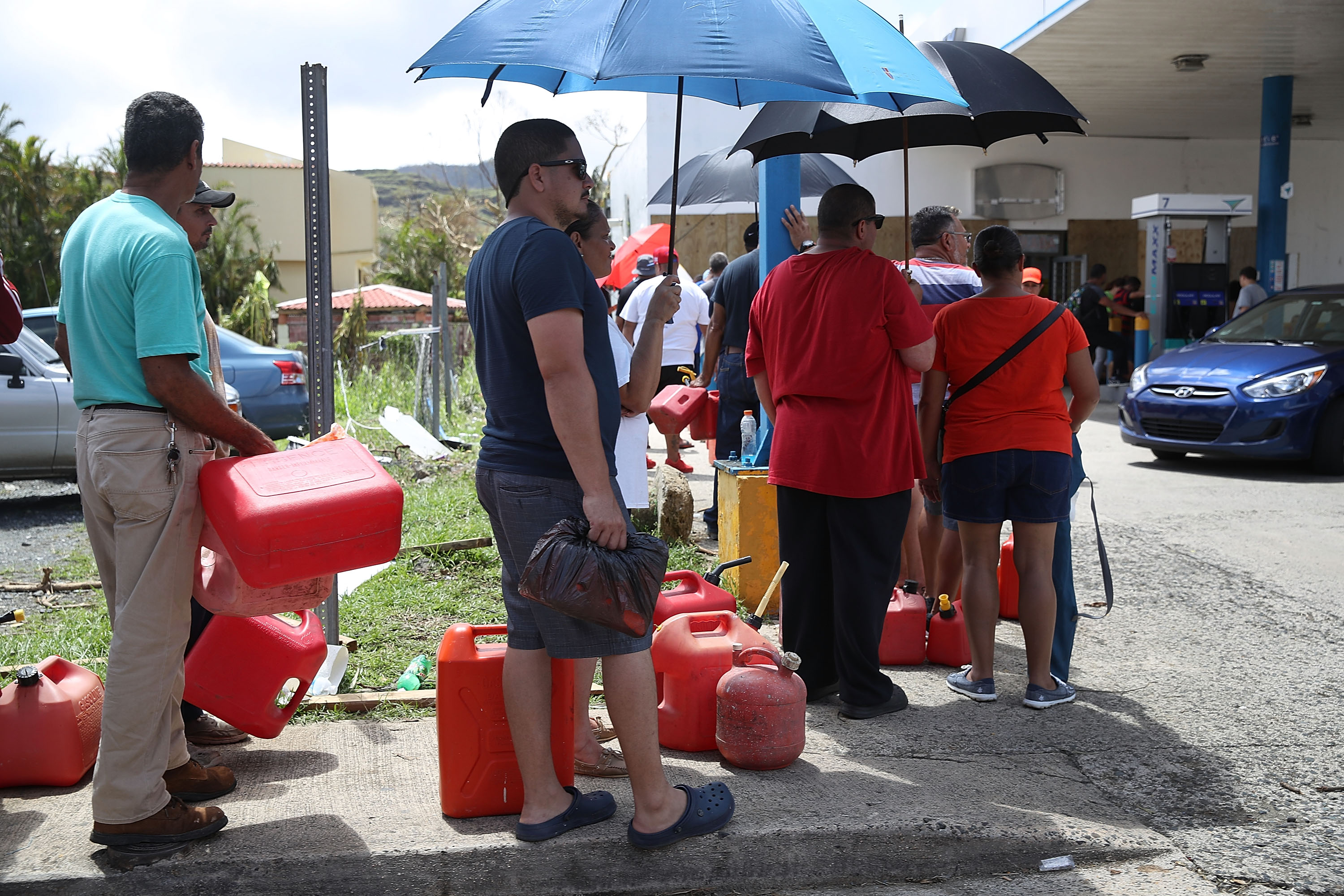 People wait in line for gas as they wait for gas, electrical and water grids to be repaired September 24, 2017 in Aibonito, Puerto Rico. Puerto Rico experienced widespread damage after Hurricane Maria, a category 4 hurricane, passed through. (Photo by Joe Raedle/Getty Images)