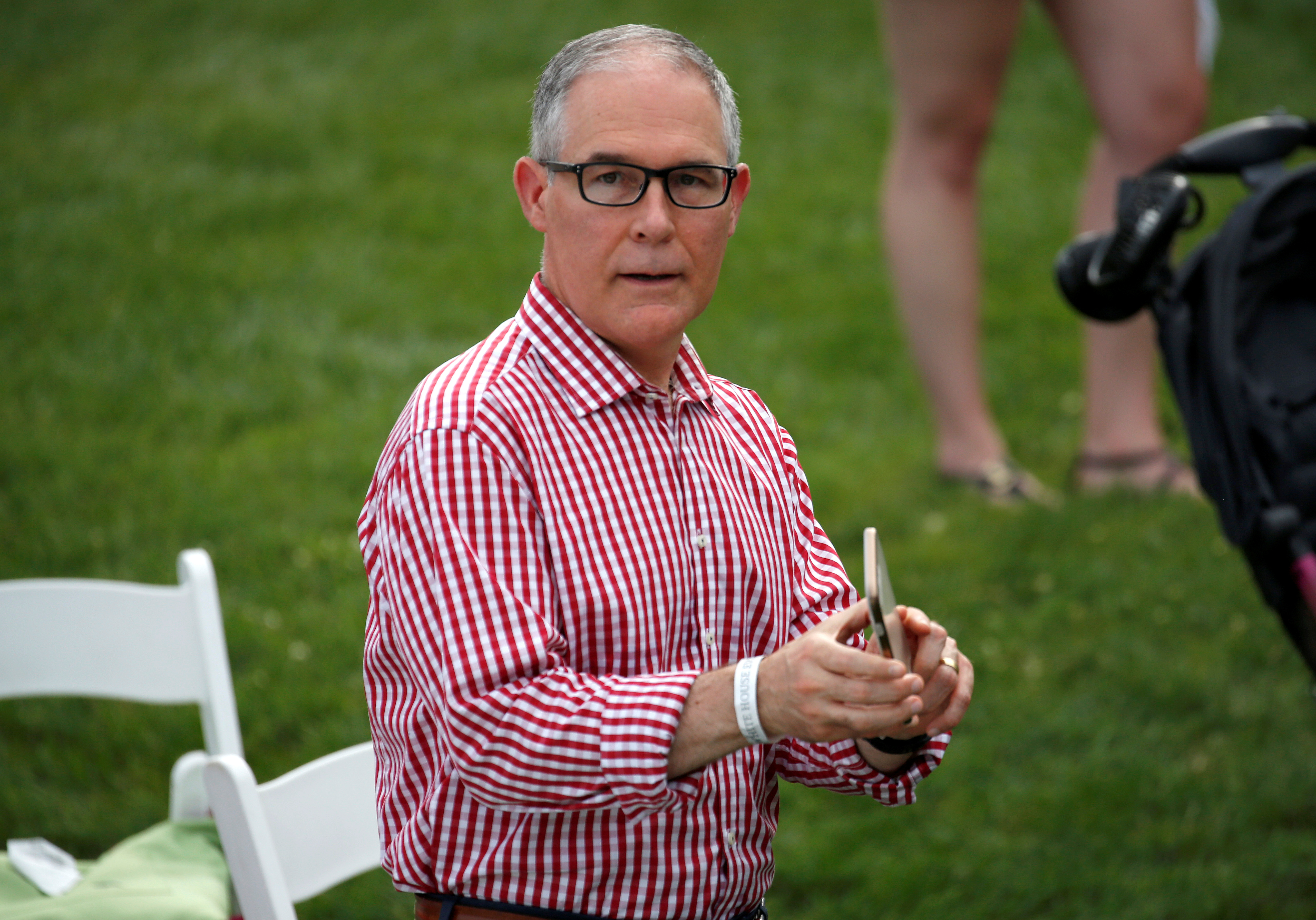 Administrator of the Environmental Protection Agency Scott Pruitt holds a mobile phone during a picnic for military families celebrating Independence Day at the White House in Washington