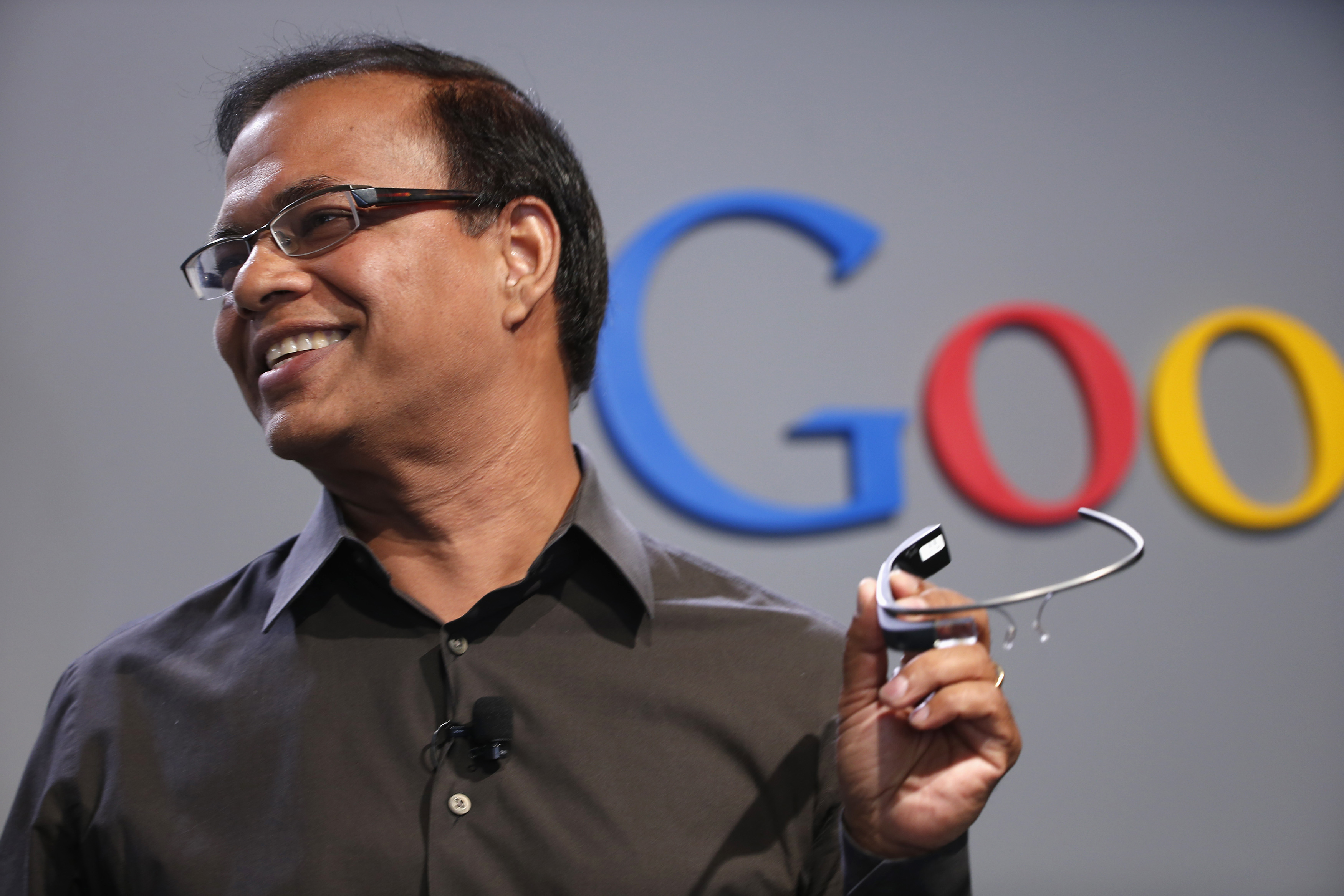 Amit Singhal, senior vice president of search at Google, holds a Google Glass as he speaks at the garage where the company was founded on Google's 15th anniversary in Menlo Park, California September 26, 2013 (REUTERS/Stephen Lam)