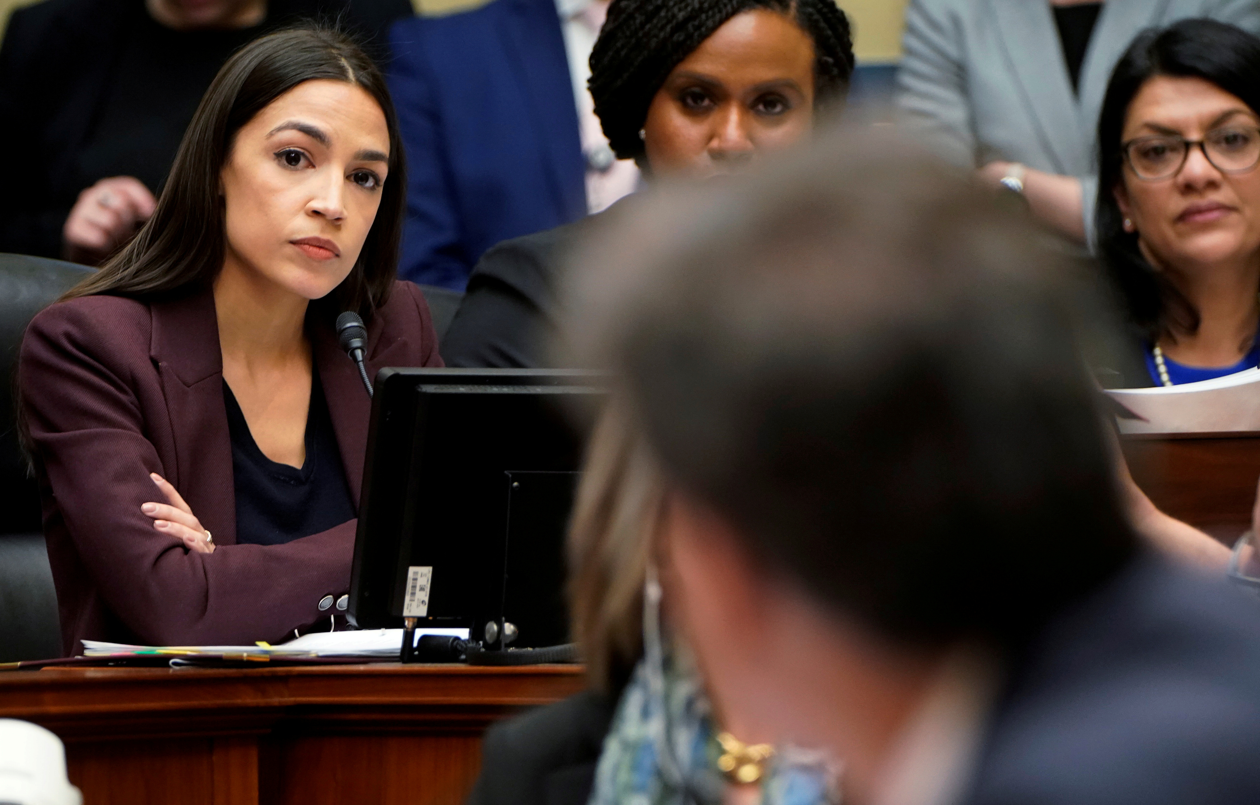 U.S. Rep. Alexandria Ocasio-Cortez (D-NY), Rep. Ayanna Pressley (D-MA) and Rep. Rashida Tlaib (D-MI) listen to former Trump personal attorney Michael Cohen answer a question from Ocasio-Cortez during his testimony at a House Committee on Oversight and Reform hearing on Capitol Hill in Washington, U.S., February 27, 2019. REUTERS/Joshua Roberts