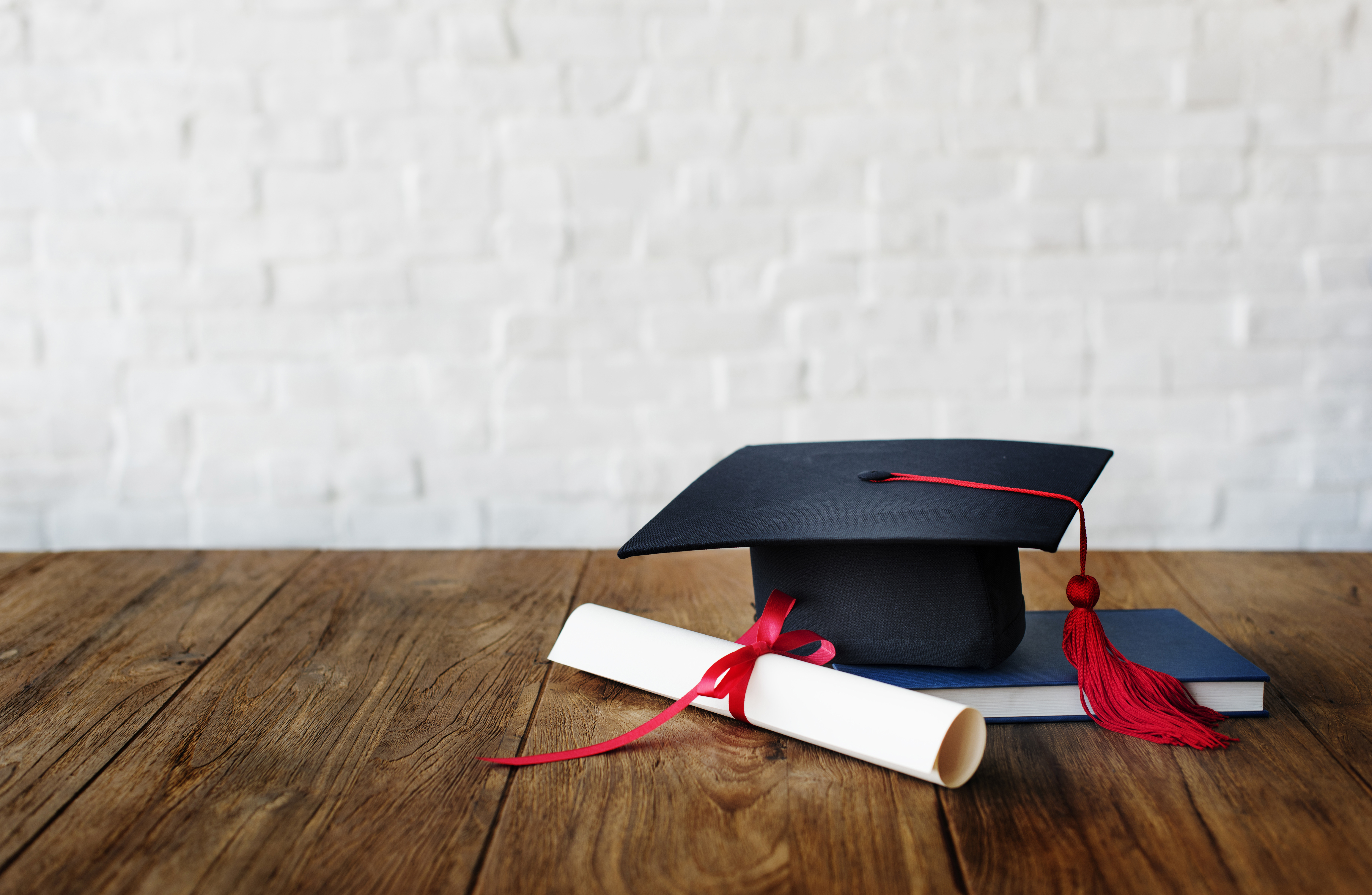 Pictured is a diploma and graduation cap. SHUTTERSTOCK/ Rawpixel.com