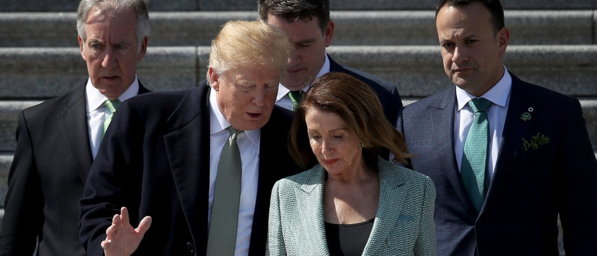 U.S. President Donald Trump confers with Speaker of the House Nancy Pelosi while departing the U.S. Capitol following a St. Patrick's Day celebration on March 14, 2019 in Washington, DC. (Photo by Win McNamee/Getty Images)