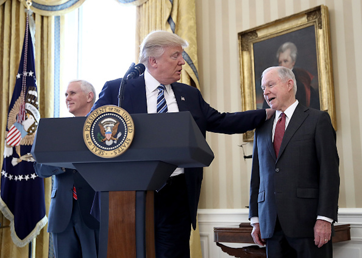 WASHINGTON, DC - FEBRUARY 09: U.S. President Donald Trump (C) put his hand on the shoulder of Sen. Jeff Sessions (R) after introducing him before Sessions's swearing in ceremony in the Oval Office of the White House February 9, 2017 in Washington, DC. Trump also signed three executive orders immediately after the swearing in ceremony. Also pictured is U.S. Vice President Mike Pence (L). (Photo by Win McNamee/Getty Images)