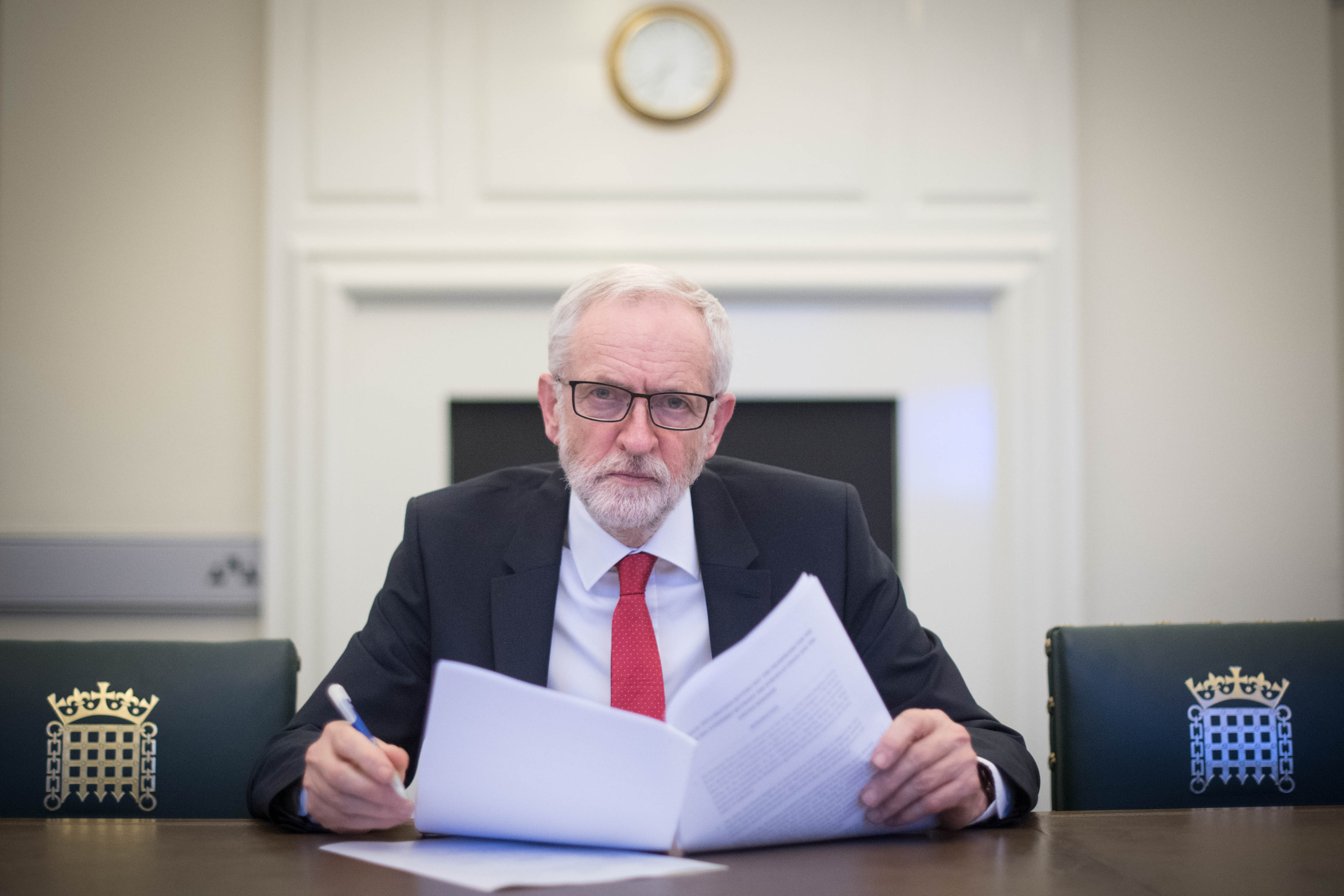 Britain's main opposition Labour Party leader Jeremy Corbyn poses with a copy of the Political Declaration setting out the framework for the future UK-EU relationship, in his office in the Houses of Parliament in London on April 2, 2019. - Prime Minister Theresa May said Tuesday she would ask the EU to delay Brexit again to avoid Britain crashing out of the bloc next week, signalling she could accept a closer relationship with Europe to break months of political deadlock. In a move which enraged the Brexit-supporting wing of her Conservative Party, she also offered to work with Labour main opposition leader Jeremy Corbyn, who favours closer ties with the European Union. Corbyn responded saying he was "very happy" to meet. (Photo by Stefan Rousseau / POOL / AFP) (Photo credit should read STEFAN ROUSSEAU/AFP/Getty Images)
