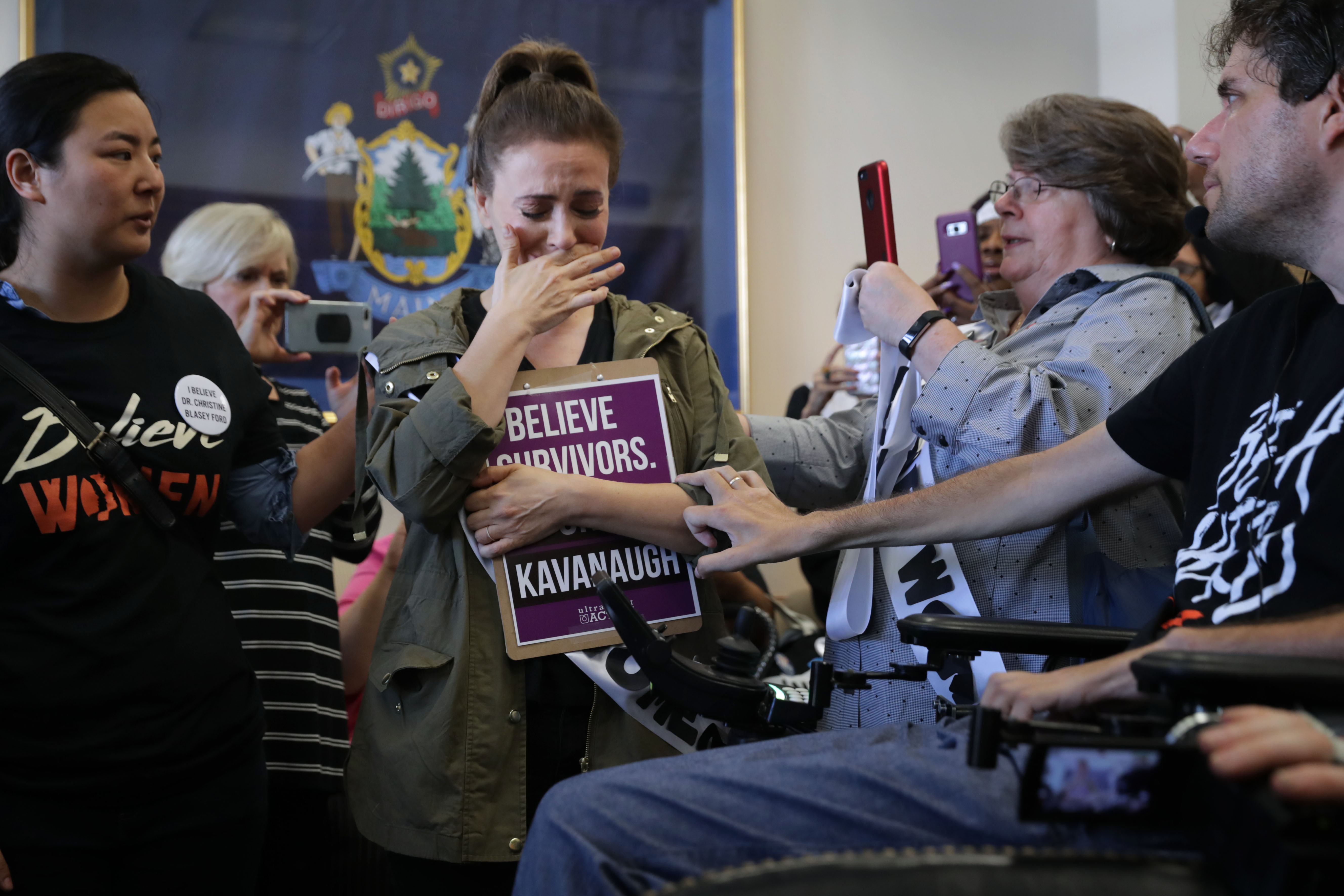Actress Alyssa Milano is comforted after telling her story of being sexually assaulted while she and dozens of other protesters demonstrate against the appointment of Supreme Court nominee Judge Brett Kavanaugh in the office of Sen. Susan Collins in the Dirksen Senate Office Building on Capitol Hill September 26, 2018 in Washington, DC. (Photo by Chip Somodevilla/Getty Images)