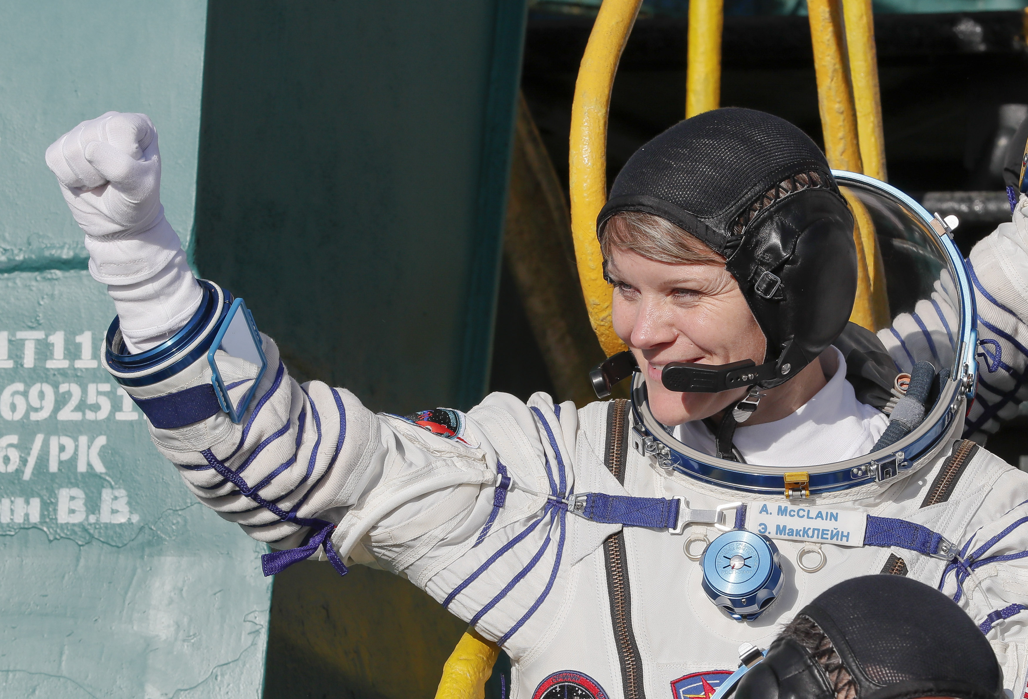NASA astronaut Anne McClain, a member of the International Space Station (ISS) expedition 58/59, gestures as she boards the Soyuz MS-11 spacecraft shortly before the launch at the Russian-leased Baikonur cosmodrome in Kazakhstan on December 3, 2018. (SHAMIL ZHUMATOV/AFP/Getty Images)