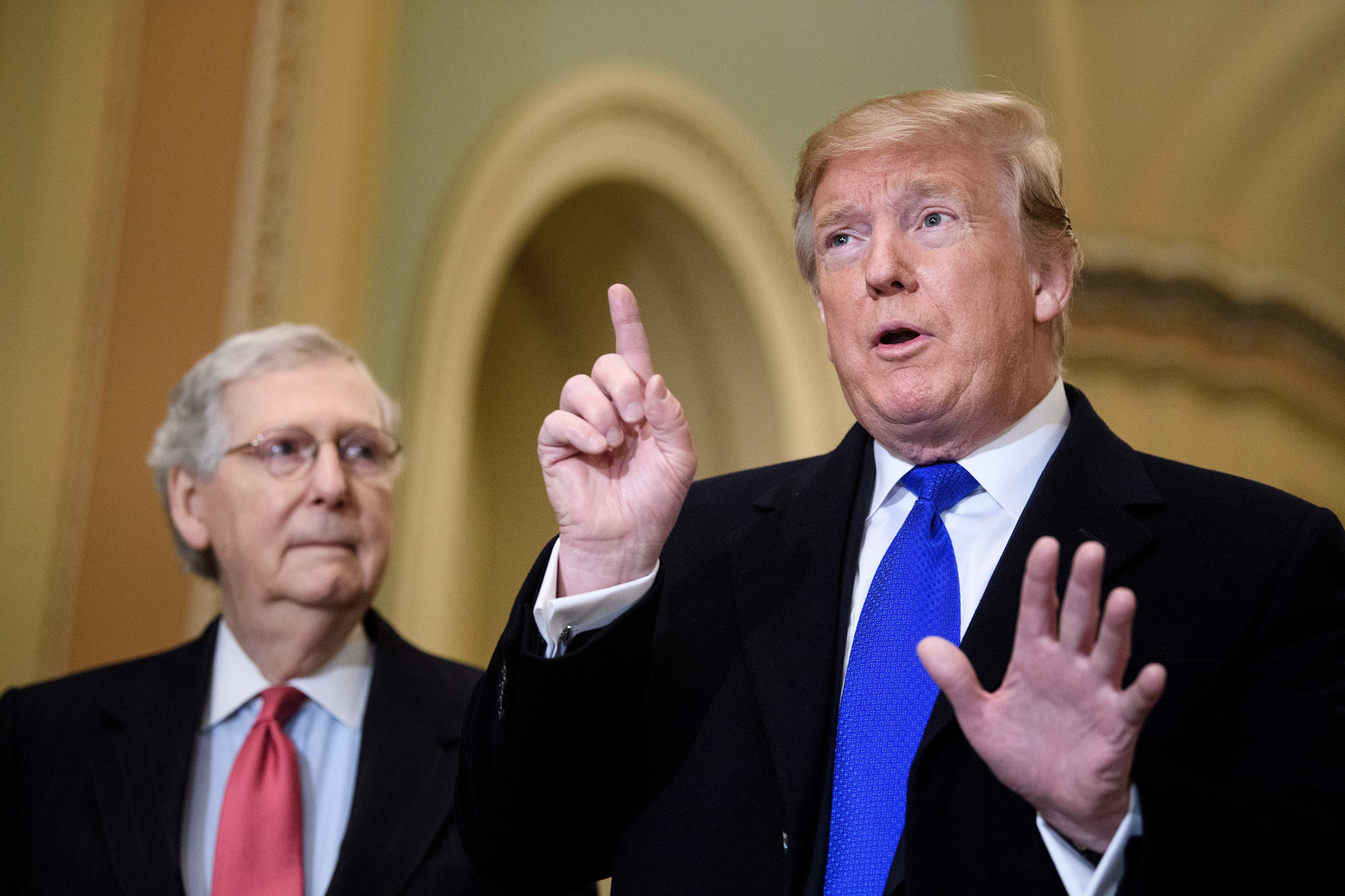 Senate Majority Leader Senator Mitch McConnell listens while US President Donald Trump speaks to reporters before a meeting with Senate Republicans on Capitol Hill March 26, 2019, in Washington, DC. (BRENDAN SMIALOWSKI/AFP/Getty Images)