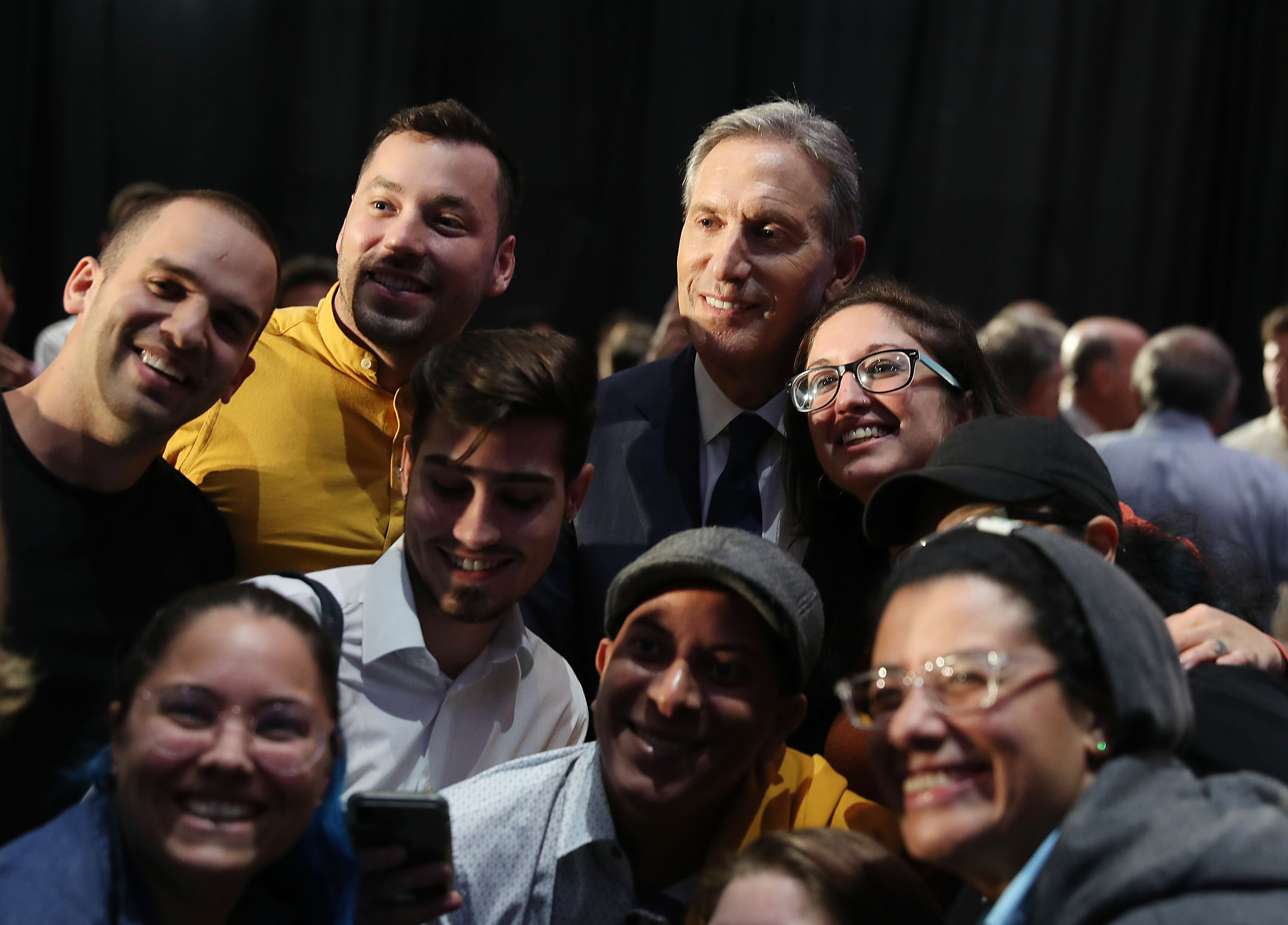 Former Starbucks CEO Howard Schultz poses for a picture with people during a stop at Miami Dade College as he seeks a possible independent presidency run on March 13, 2019 in Miami, Florida. (Photo by Joe Raedle/Getty Images)