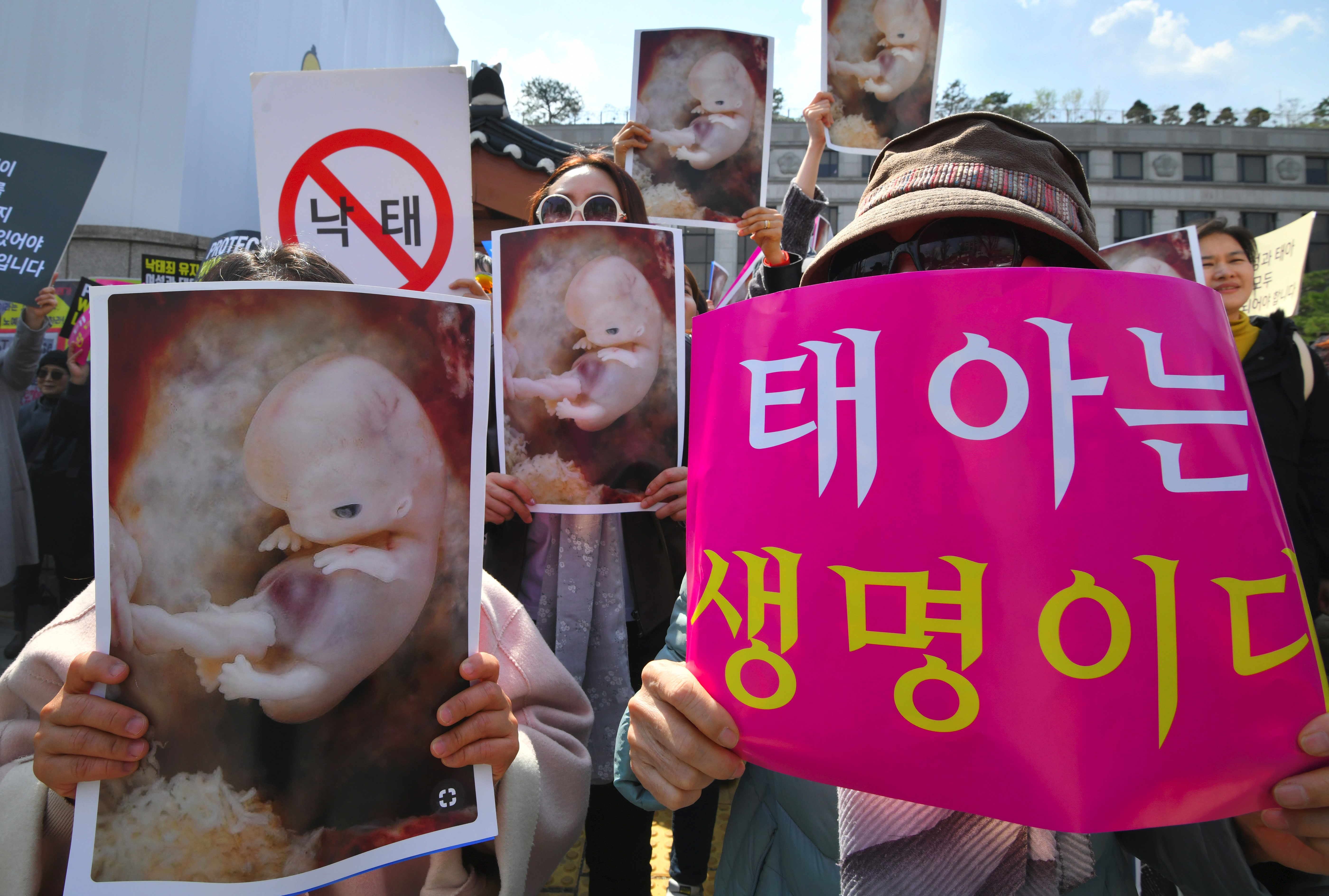 South Korean pro-lifers hold placards showing images of embryos during a rally supporting an abortion ban outside the constitutional court in Seoul on April 11, 2019. (JUNG YEON-JE/AFP/Getty Images)