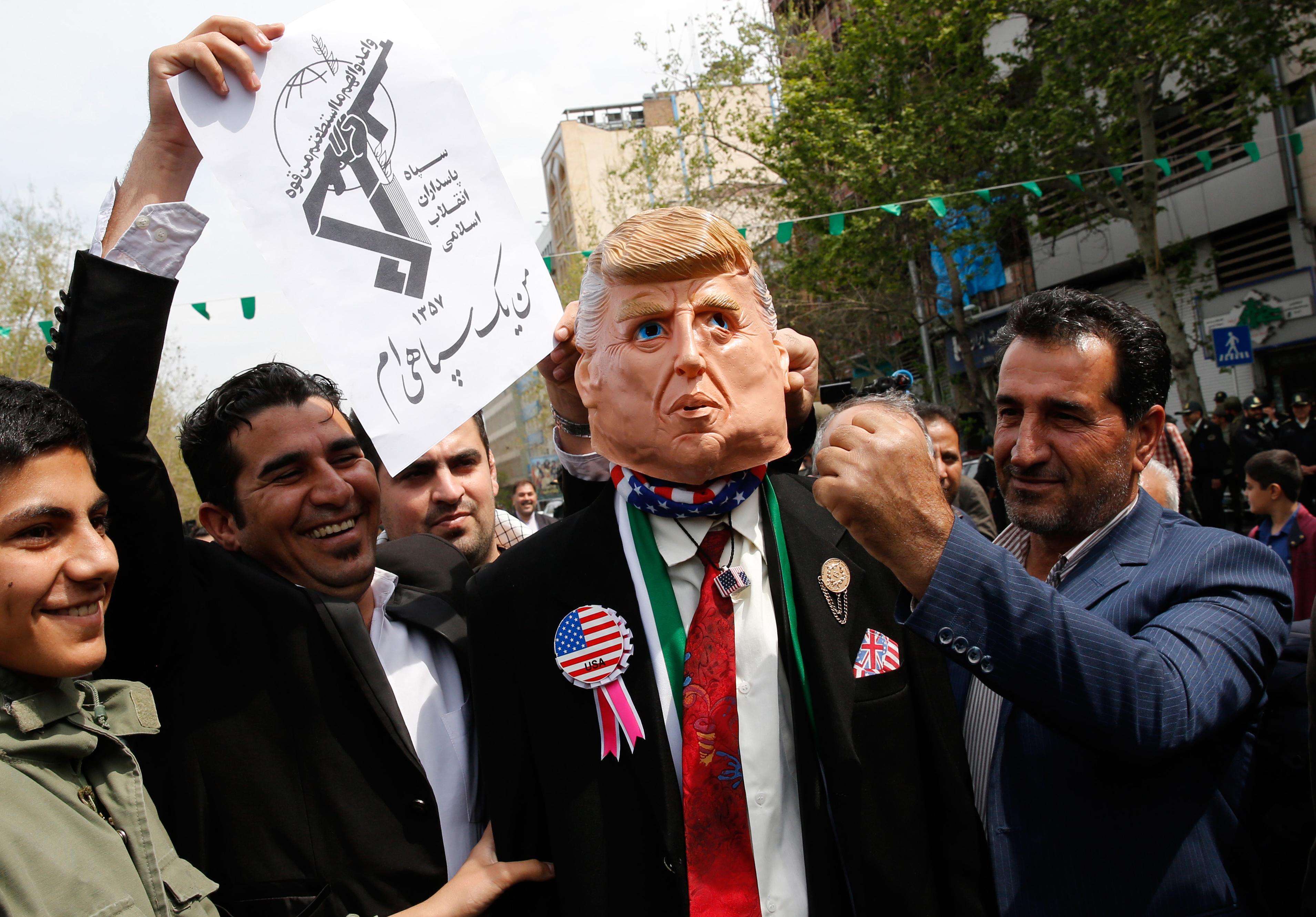 Iranians pretend to hit a man wearing a mask of US President Donal Trump during an anti-US rally following Friday prayers in Tehran on April 12, 2019. (-/AFP/Getty Images)