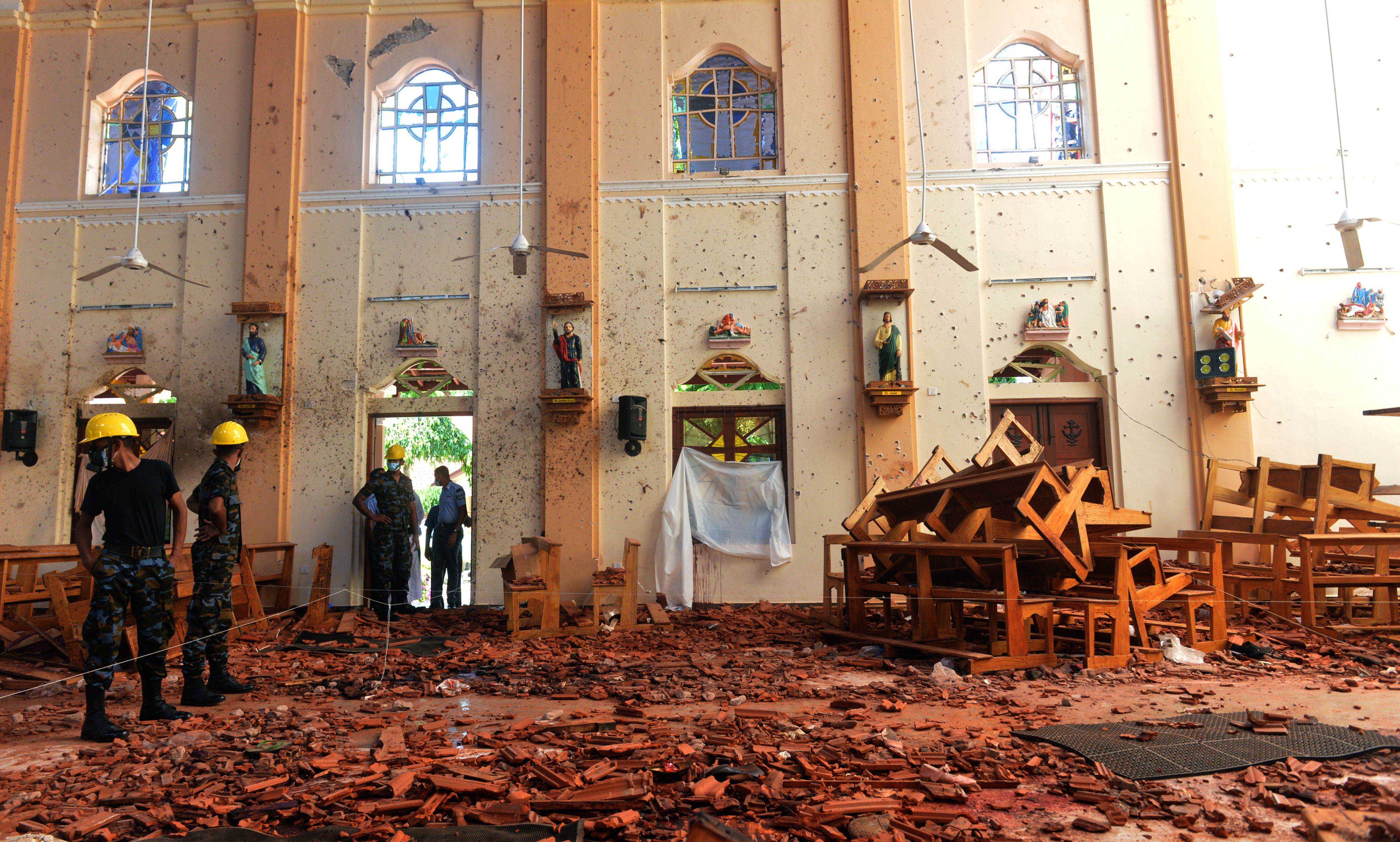 Security personnel inspect the interior of St. Sebastian's Church in Negombo on April 22, 2019, a day after the church was hit in series of bomb blasts targeting churches and luxury hotels in Sri Lanka. (ISHARA S. KODIKARA/AFP/Getty Images)