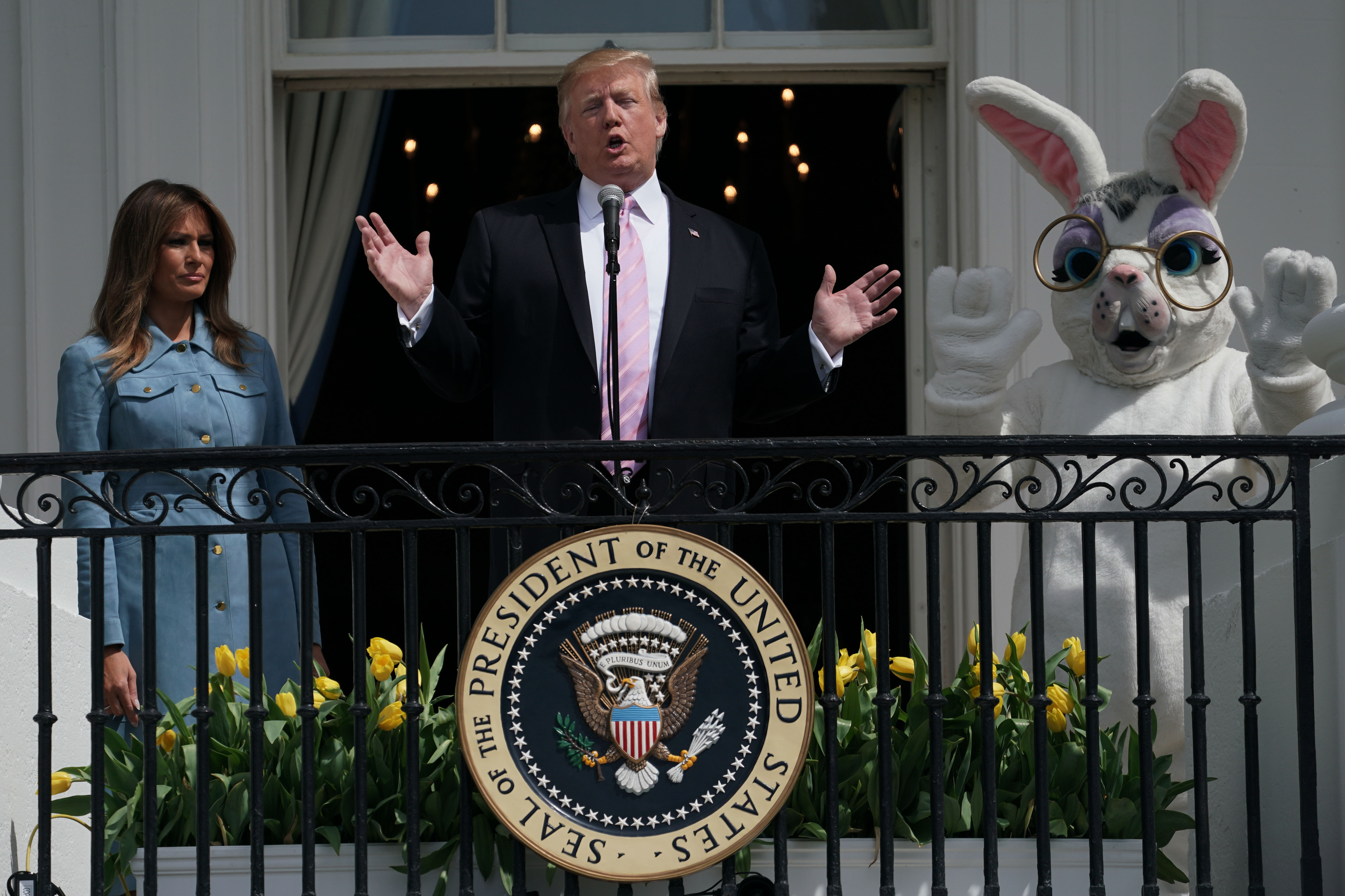 WASHINGTON, DC - APRIL 22: U.S. President Donald Trump speaks as first lady Melania Trump listens during the 141st Easter Egg Roll on the South Lawn of the White House April 22, 2019 in Washington, DC. About 30,000 people are expected to attend the annual tradition of rolling colored eggs down the South Lawn of the White House that dates back to the Rutherford B. Hayes Administration in 1878. (Photo by Alex Wong/Getty Images)