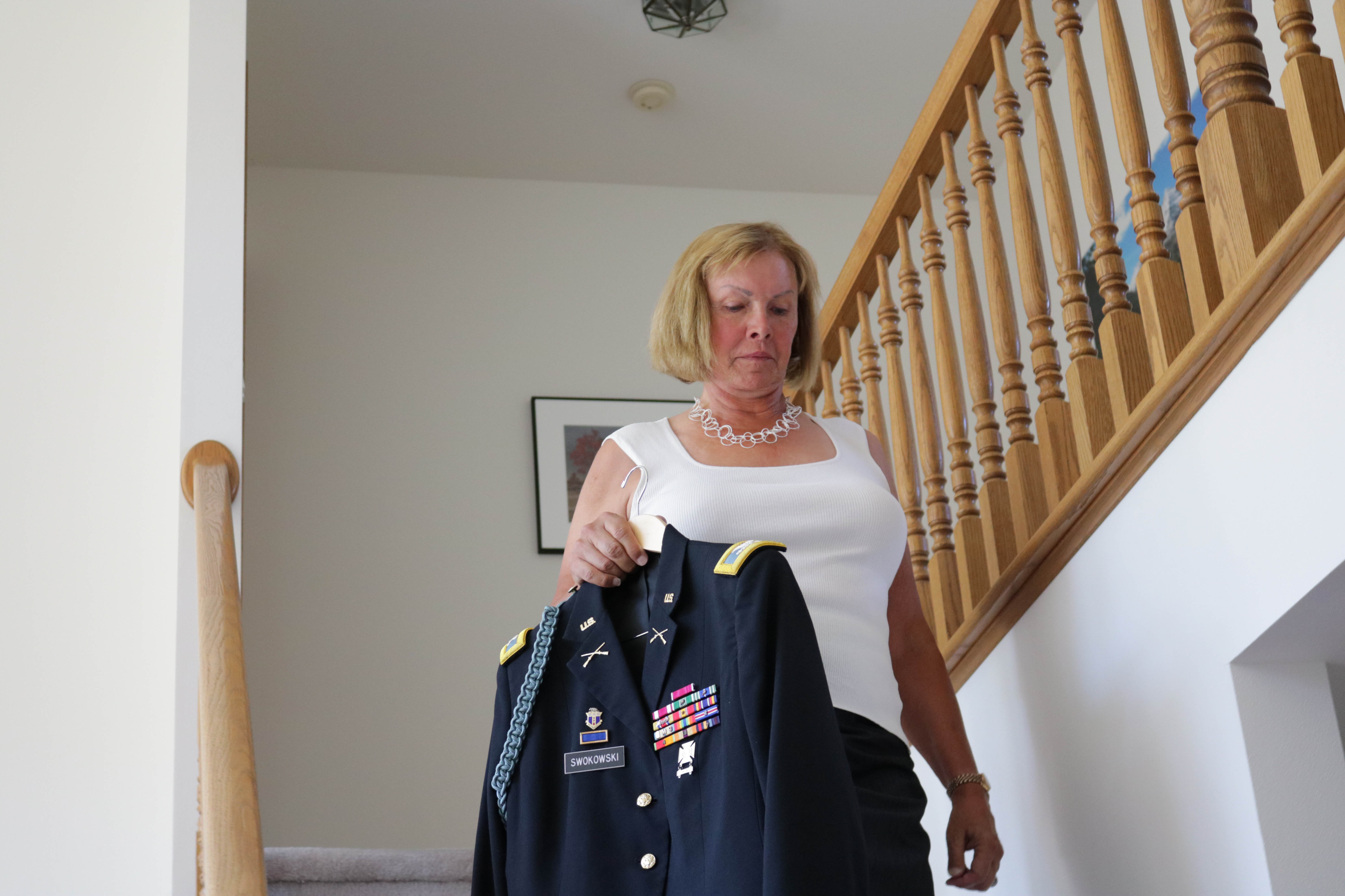 Former US Army Colonel and transgender Sheri Swokowski carries her uniform July 27, 2017 in DeForest, Wisconsin, the day following US President Donald Trumps announcing of a ban on transgender military members. DEREK R. HENKLE/AFP/Getty Images